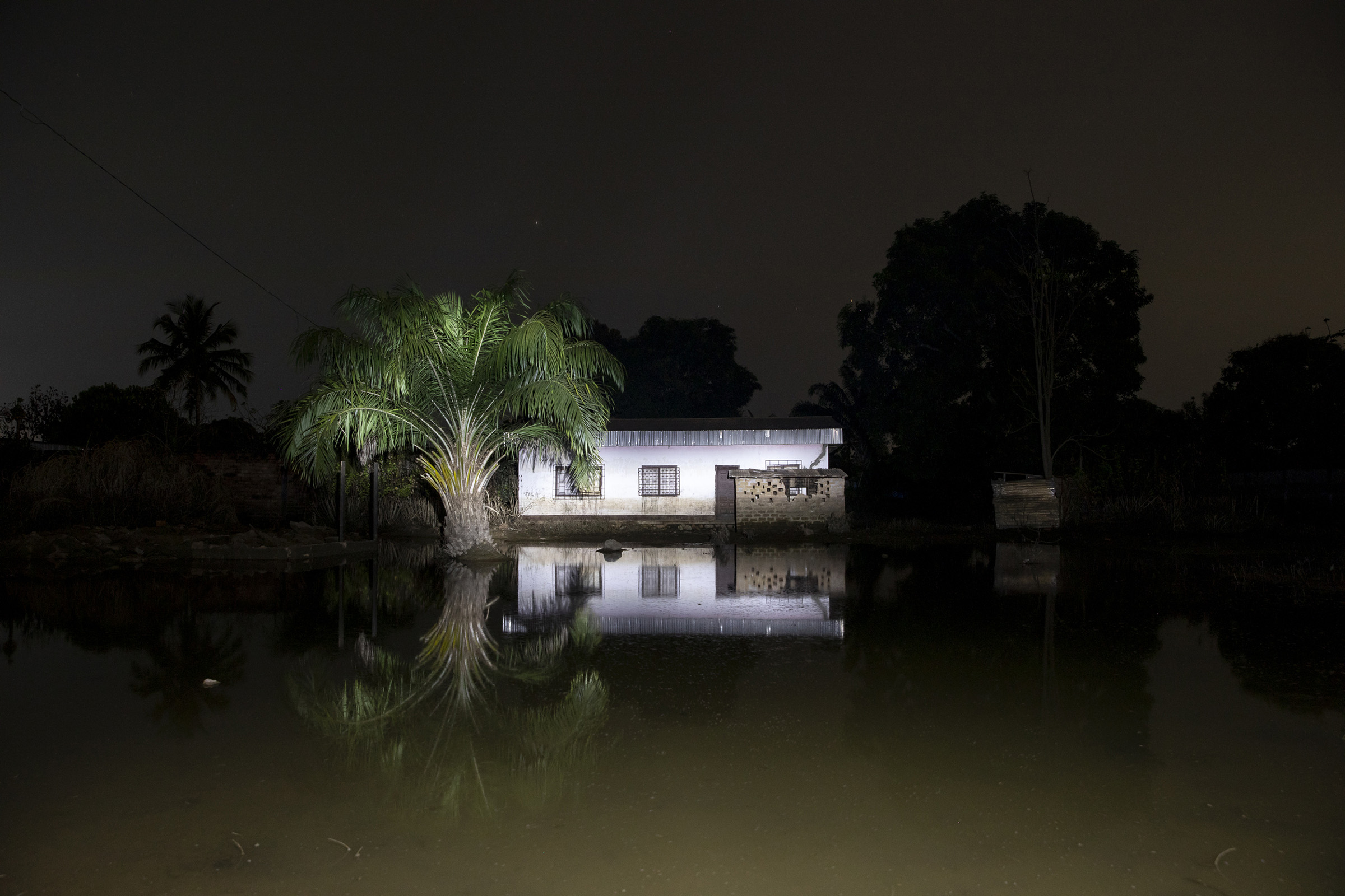 A house is seen at night in a flooded neighbourhood of Bangui, capital of the Central African Republic, on Nov. 22, 2019 during a night patrol. (Adrienne Surprenant—Greenpeace)