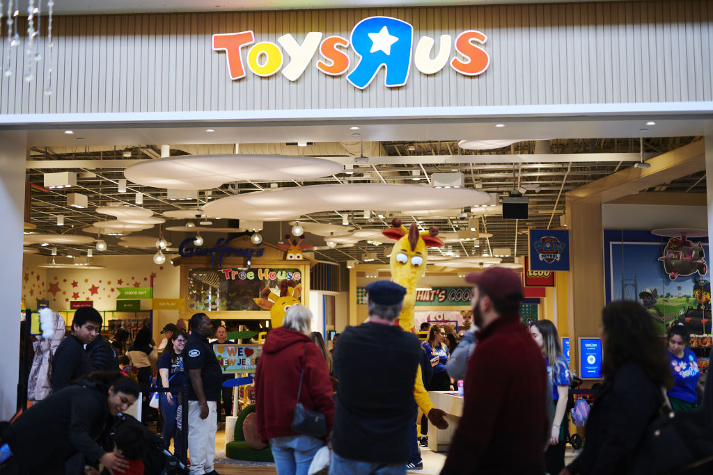 Shoppers pass in front of a Toys 'R' Us Inc. store at the Westfield Garden State Plaza mall on Black Friday in Paramus, N.J., on Nov. 29, 2019. (Gabby Jones—Getty Images)