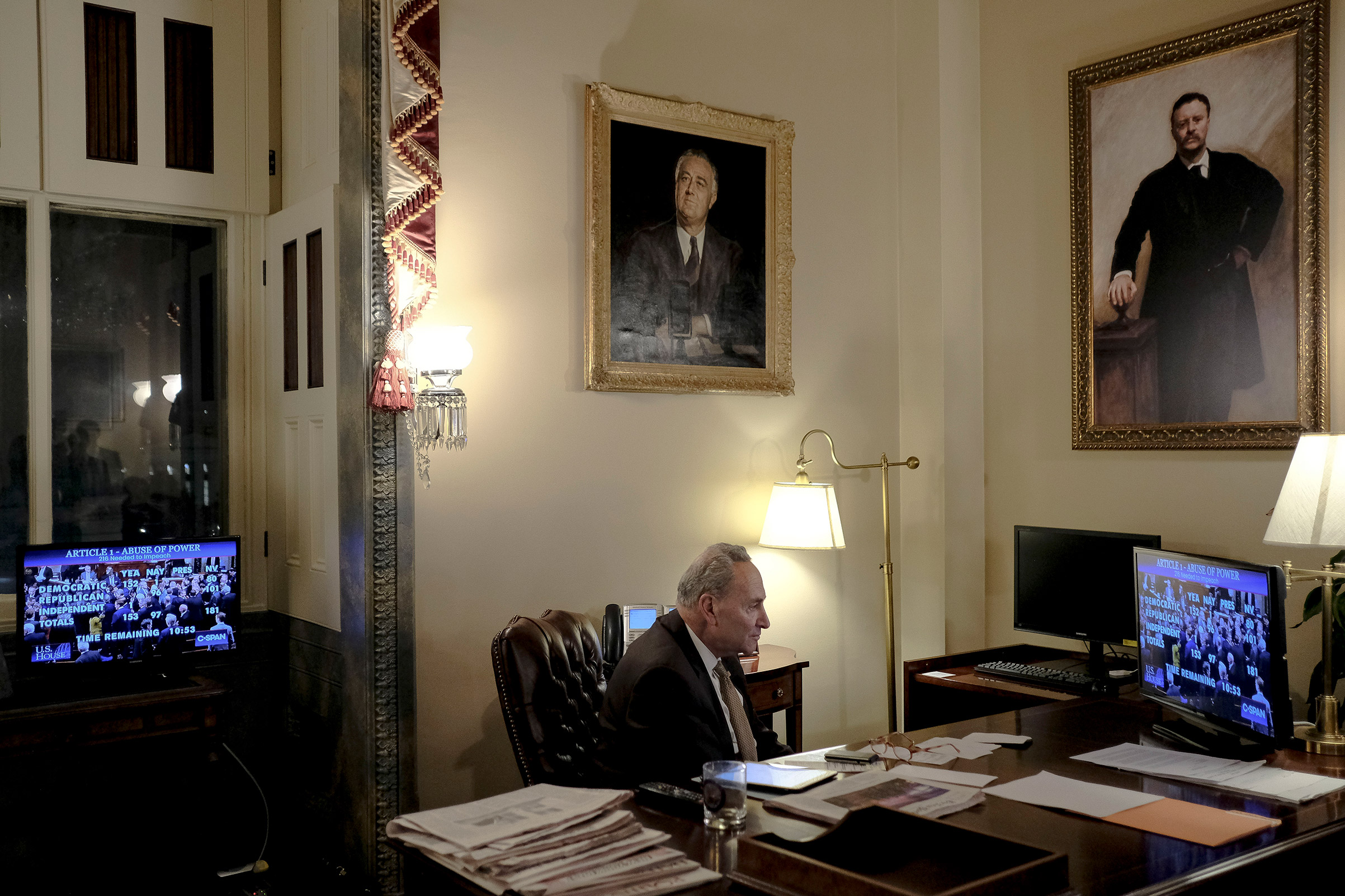 Senate Minority Leader Sen. Chuck Schumer of N.Y., watches the House vote on articles of impeachment in his office at the Capitol in Washington, D.C. on Dec. 18, 2019. (Gabriella Demczuk for TIME)