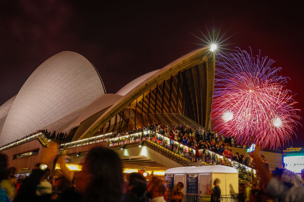 Fireworks explode over the Sydney Harbour Bridge and Sydney Opera House during the midnight display during New Year's Eve celebrations on January 01, 2020 in Sydney, Australia. (Hanna Lassen—Getty Images)