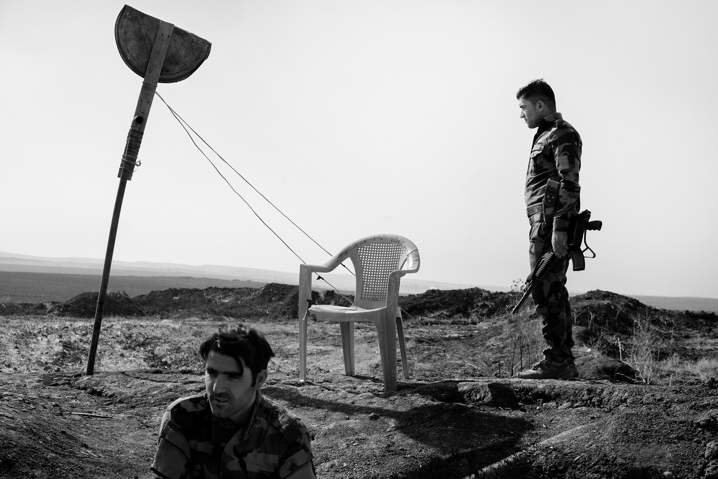 Kurdish fighters guard the new border between Kurdistan Regional Government-controlled territory and areas under the control of the Iraqi army near the town of Bashiqa, liberated from ISIS in 2016 by Iraqi and Kurdish forces. Nov. 25 issue. (Moises Saman—Magnum Photos for TIME)