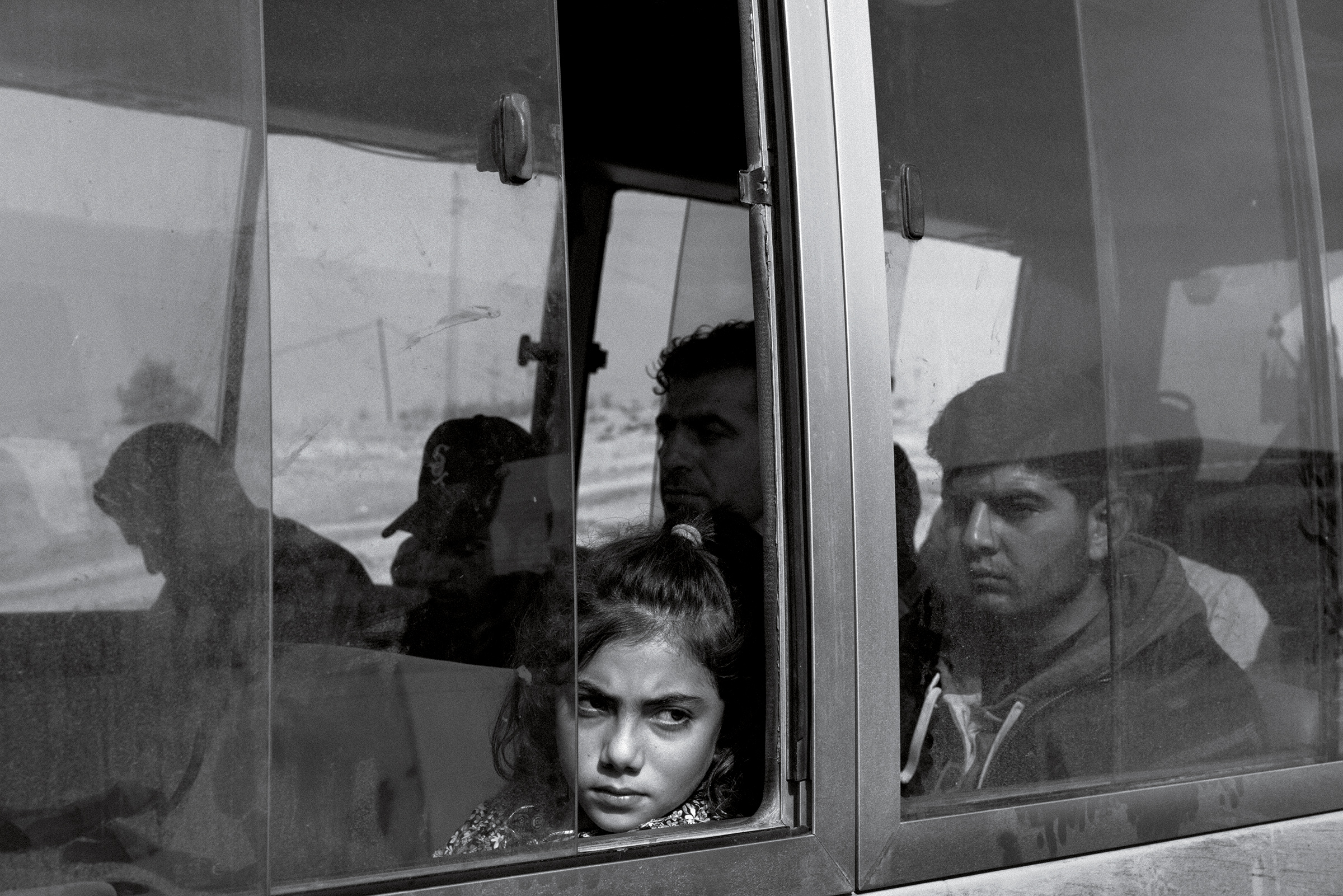 Nuhat Abdul Hamid, 9, from the Syrian Kurdish town of Darbasiyah, aboard a bus transporting refugees to the Bardarash camp in Iraq on Nov. 1. Nov. 25 issue. (Moises Saman—Magnum Photos for TIME)
