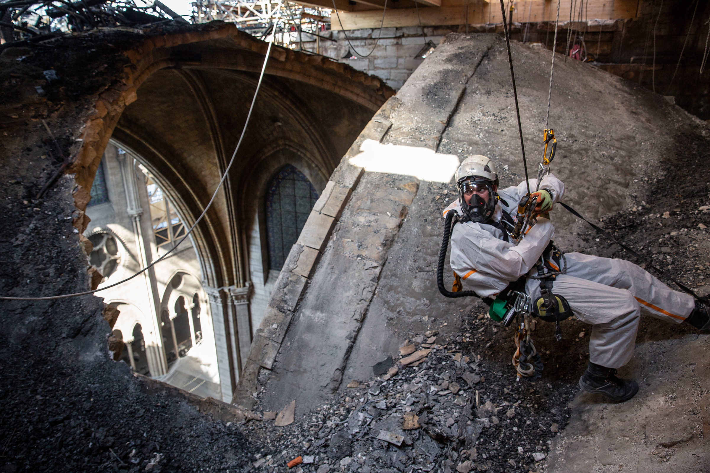 A technician near an open part of Notre Dame's roof in Paris on June 25. After the April fire, some sections of the cathedral have since been exposed to rainfall and high temperatures that France has experienced. Aug. 5 issue. (Patrick Zachmann—Magnum Photos for TIME)