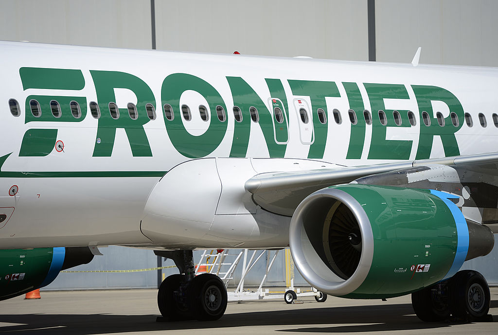 Frontier employees and executives physically pull a 46-ton Airbus A320 out of the Frontier Airlines hanger at Denver International Airport in Denver on Sept. 09, 2014. (Kathryn Scott Osler/The Denver Post—Getty Images)