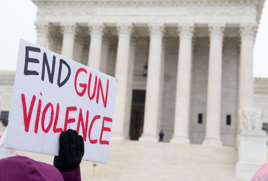 Supporters of gun control and firearm safety measures hold a protest rally outside the US Supreme Court as the Court hears oral arguments in State Rifle and Pistol v. City of New York, NY, in Washington, DC, on December 2, 2019. (Saul Loeb — AFP/Getty Images)