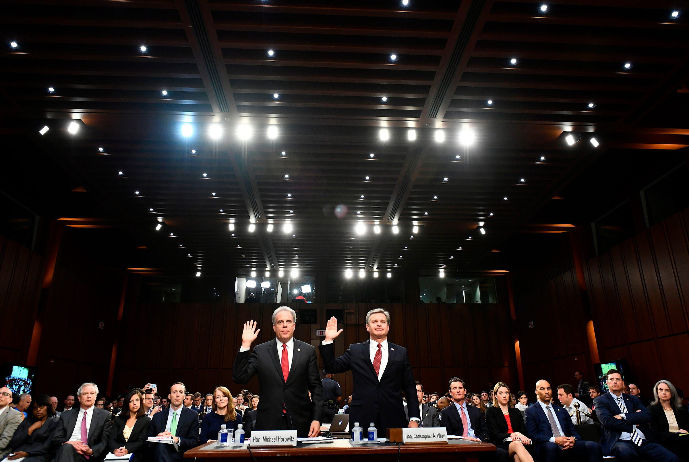 Justice Department Inspector General Michael Horowitz, left, and FBI Director Christopher Wray take an oath before testifying to the Senate Judiciary Committee in Washington, DC on June 18, 2018. (Mandel Ngan—AFP/Getty Images)