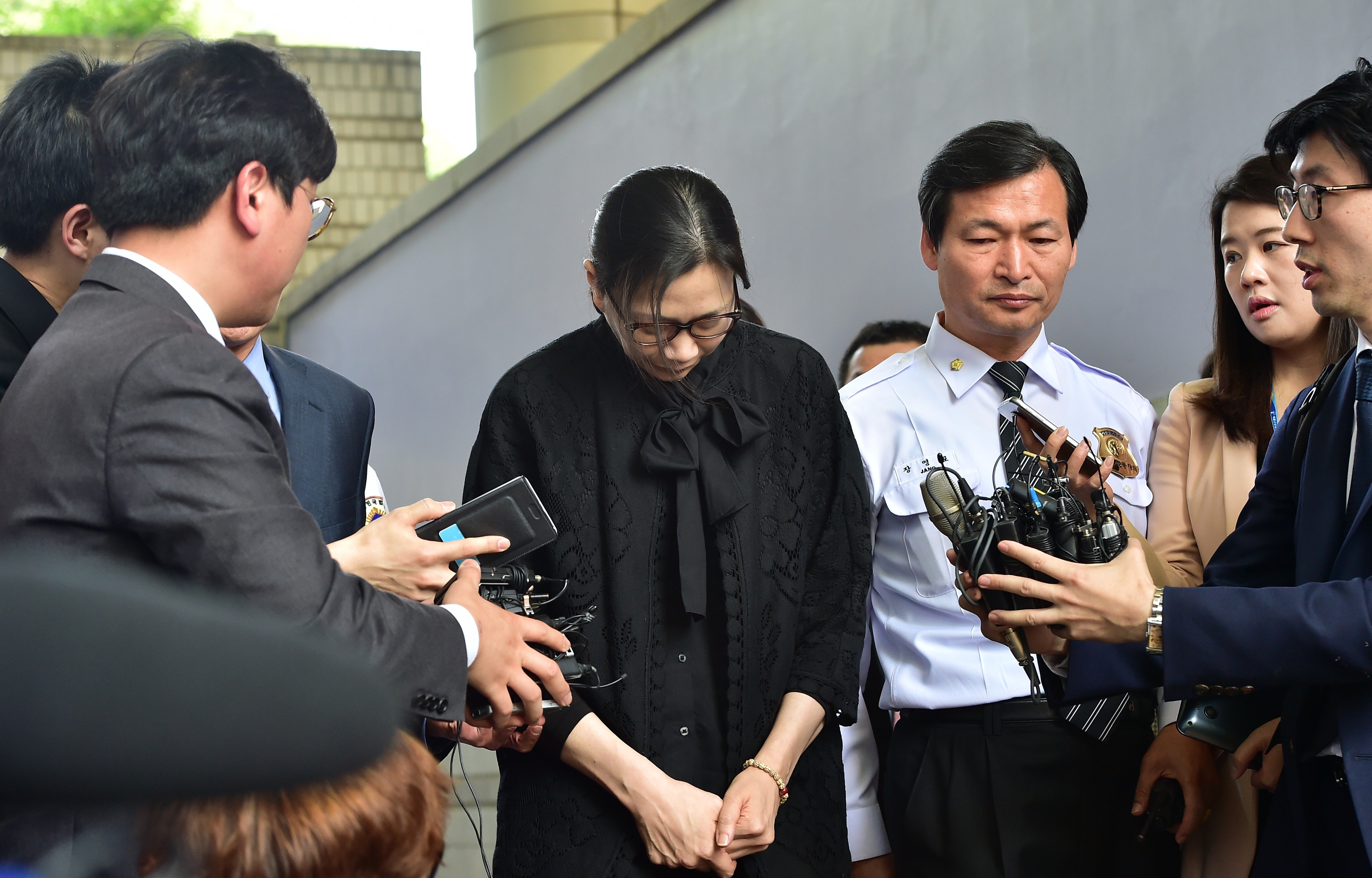 Former Korean Air executive Cho Hyun-Ah (Heather Cho) is surrounded by journalists after she received a suspended jail sentence and was freed by a Seoul appeals court on May 22, 2015. (Jung Yeon-Je—AFP/Getty Images)