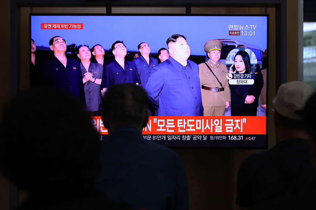 People watch a TV showing a file image of a North Korean missile launch at the Seoul Railway Station in South Korea on Oct 2, 2019. (Chung Sung-jun—Getty Images)
