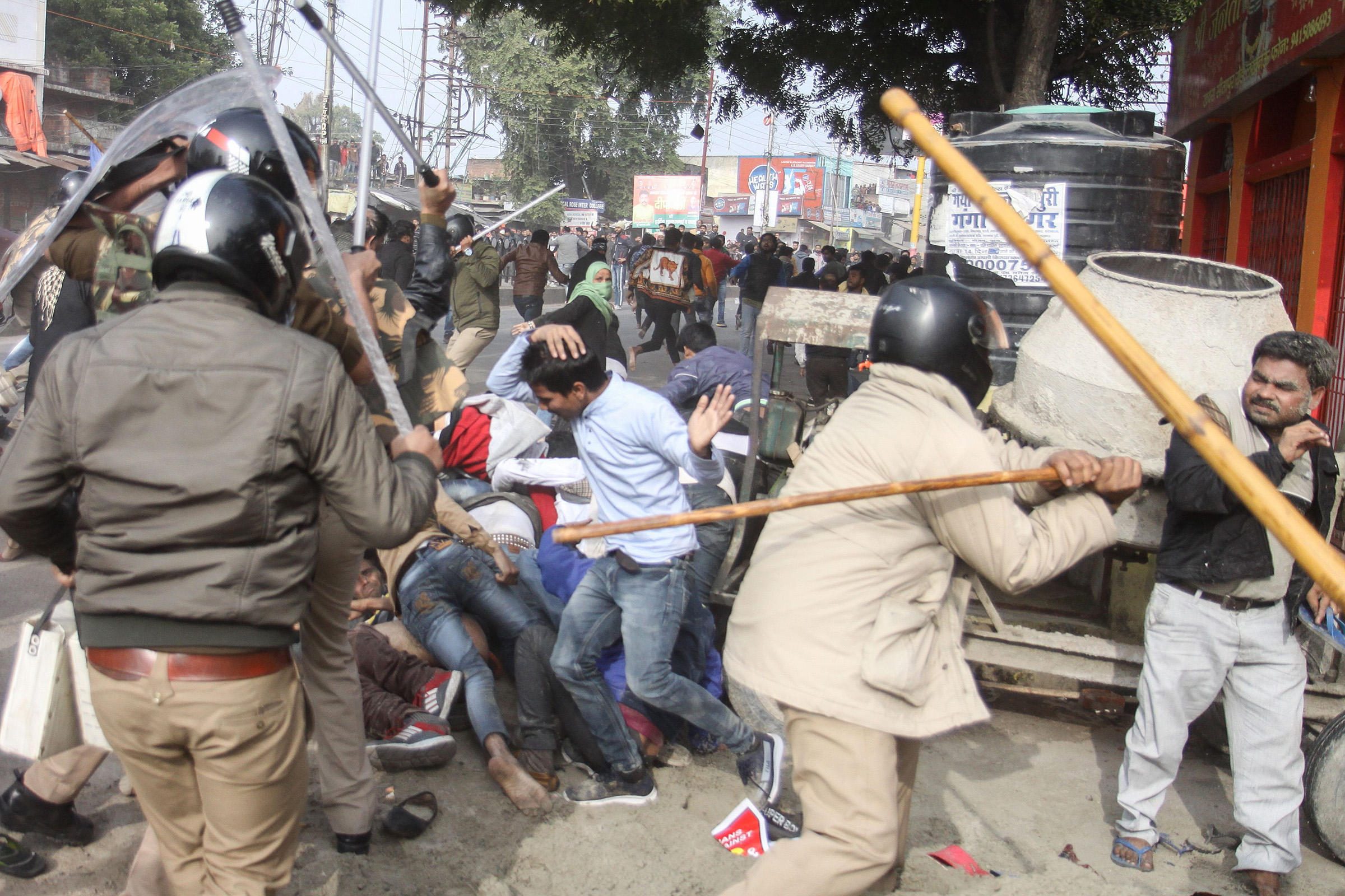 Police beat protesters with sticks during a demonstration against India's new citizenship law in Lucknow, Uttar Pradesh, India on Dec. 19, 2019.  (STR/AFP via Getty Images)