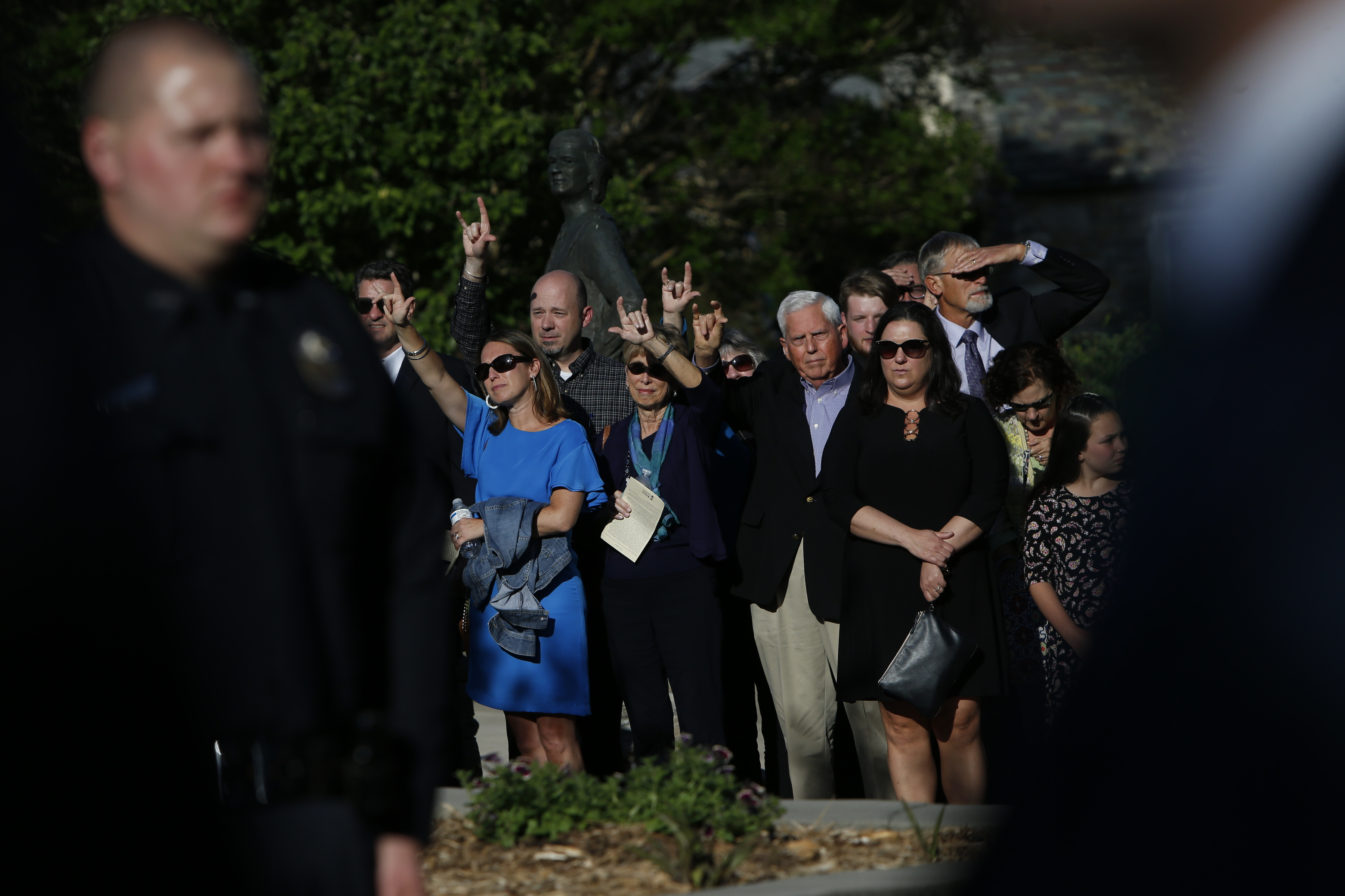 Mourners sign "I love you" as the casket carrying UNC Charlotte student Riley Howell is taken to a waiting hearse from his celebration of life service on May 5, 2019 in Waynesville, North Carolina. (Brian Blanco—Getty Images))