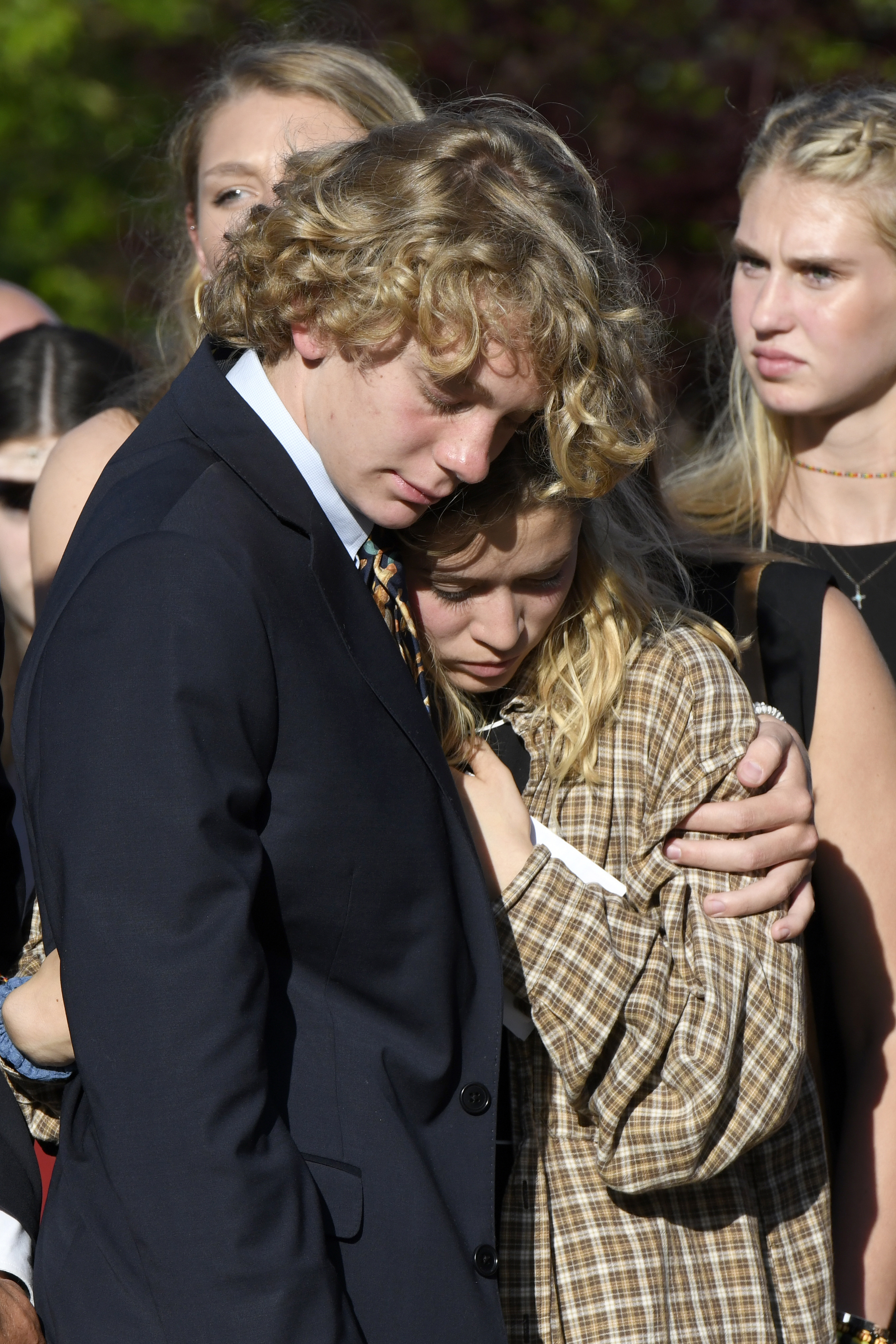 Riley Howell's brother, Teddy Howell, and girlfriend, Lauren Westmoreland, comfort each other after a memorial service f in Lake Junaluska, N.C., on May 5, 2019. (Kathy Kmonicek—AP)
