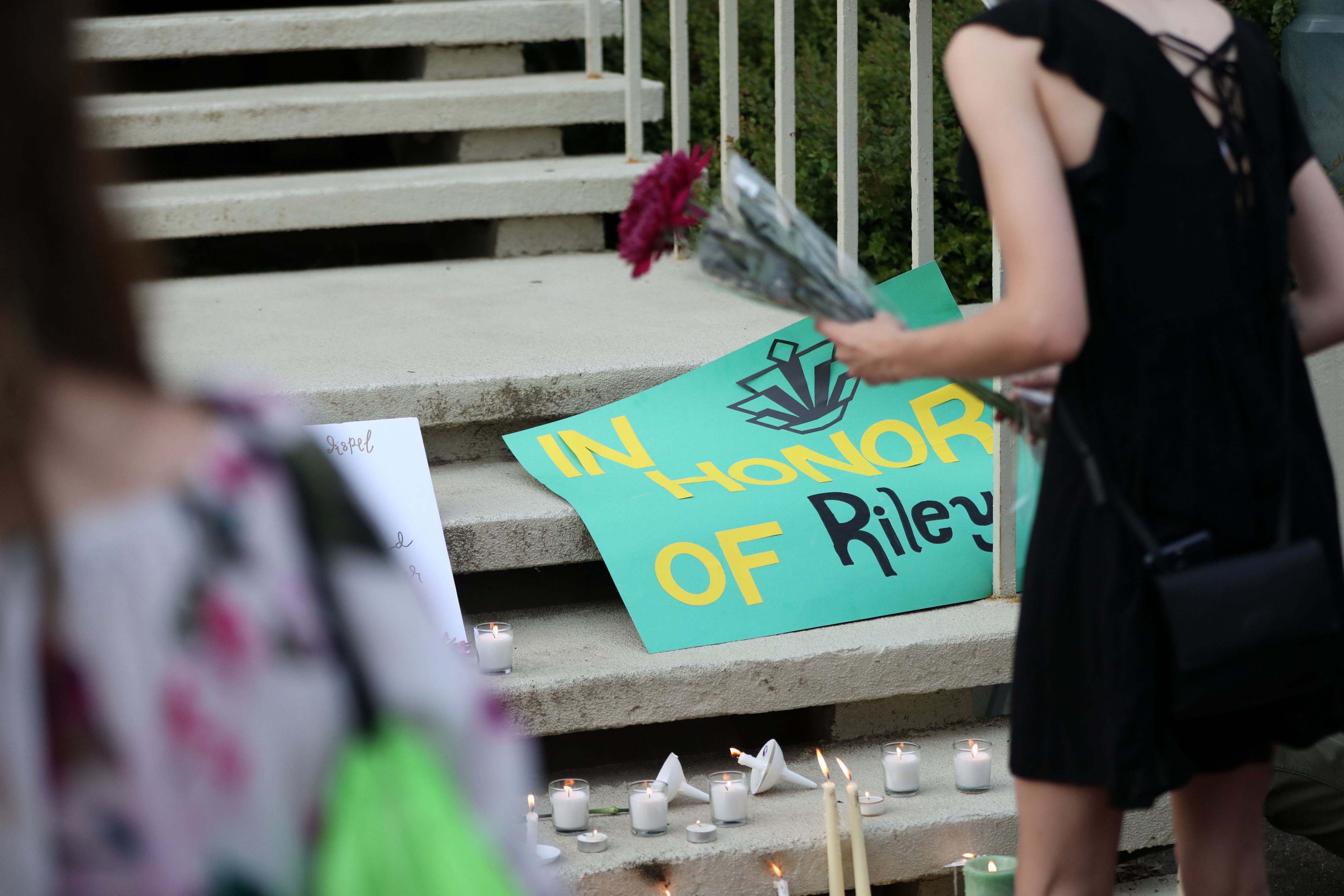 Students lay candles and flowers at the steps of Kennedy Hall to honor the victims of a shooting the day earlier at the University of North Carolina Charlotte, in Charlotte, North Carolina on May 1, 2019. (Logan Cyrus—AFP/Getty Images)