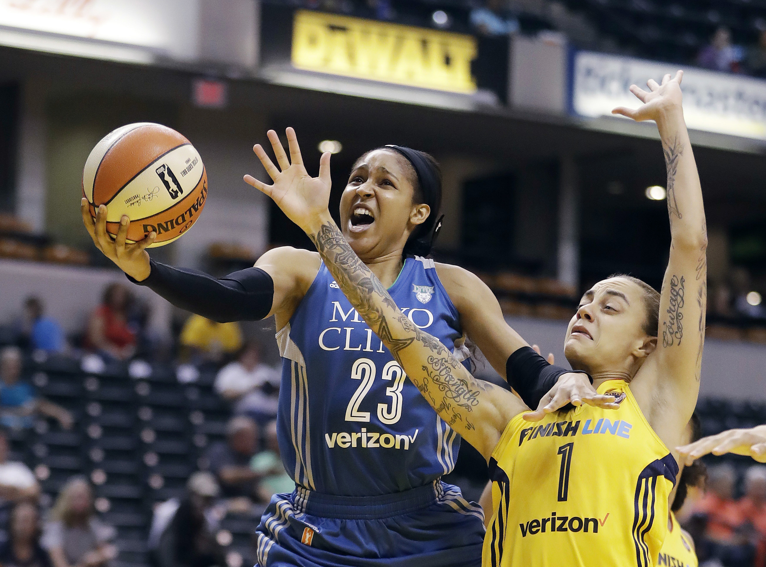 FILE - In this Aug. 30, 2017, file photo, Minnesota Lynx's Maya Moore, left, shoots against Indiana Fever's Jazmon Gwathmey during the first half of a WNBA basketball game in Indianapolis. Moore will sit out a second straight WNBA season in 2020 to continue her push for criminal justice reform. (Darron Cummings - The Associated Press)