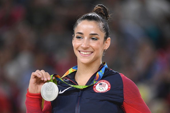 U.S. gymnast Alexandra Raisman celebrates on the podium of the women's floor event final of the Artistic Gymnastics at the Olympic Arena during the Rio 2016 Olympic Games in Rio de Janeiro on August 16, 2016.