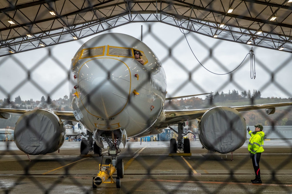 Workers inspect a Boeing 737 MAX aircraft owned by American Airlines at Boeing's Renton Factory on October 20, 2019 in Renton, Washington. (Gary He–Getty Images)