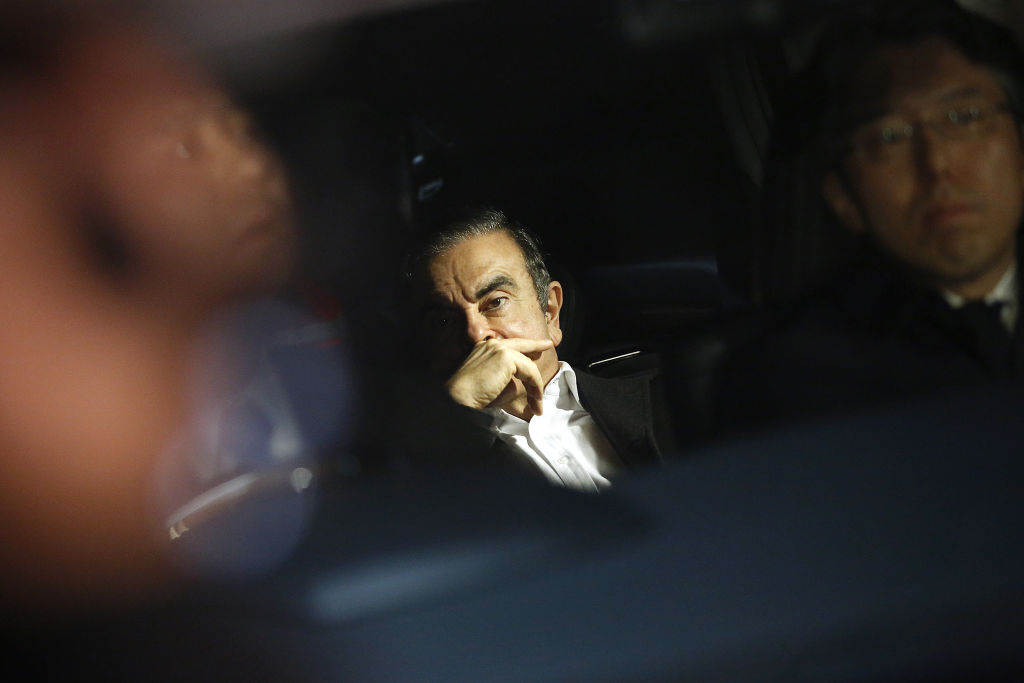 Carlos Ghosn, former chairman of Nissan Motor Co., center, sits in a vehicle as he leaves his lawyer's office in Tokyo, Japan, on March 6, 2019. (Takaaki Iwabu—Bloomberg/Getty Images)