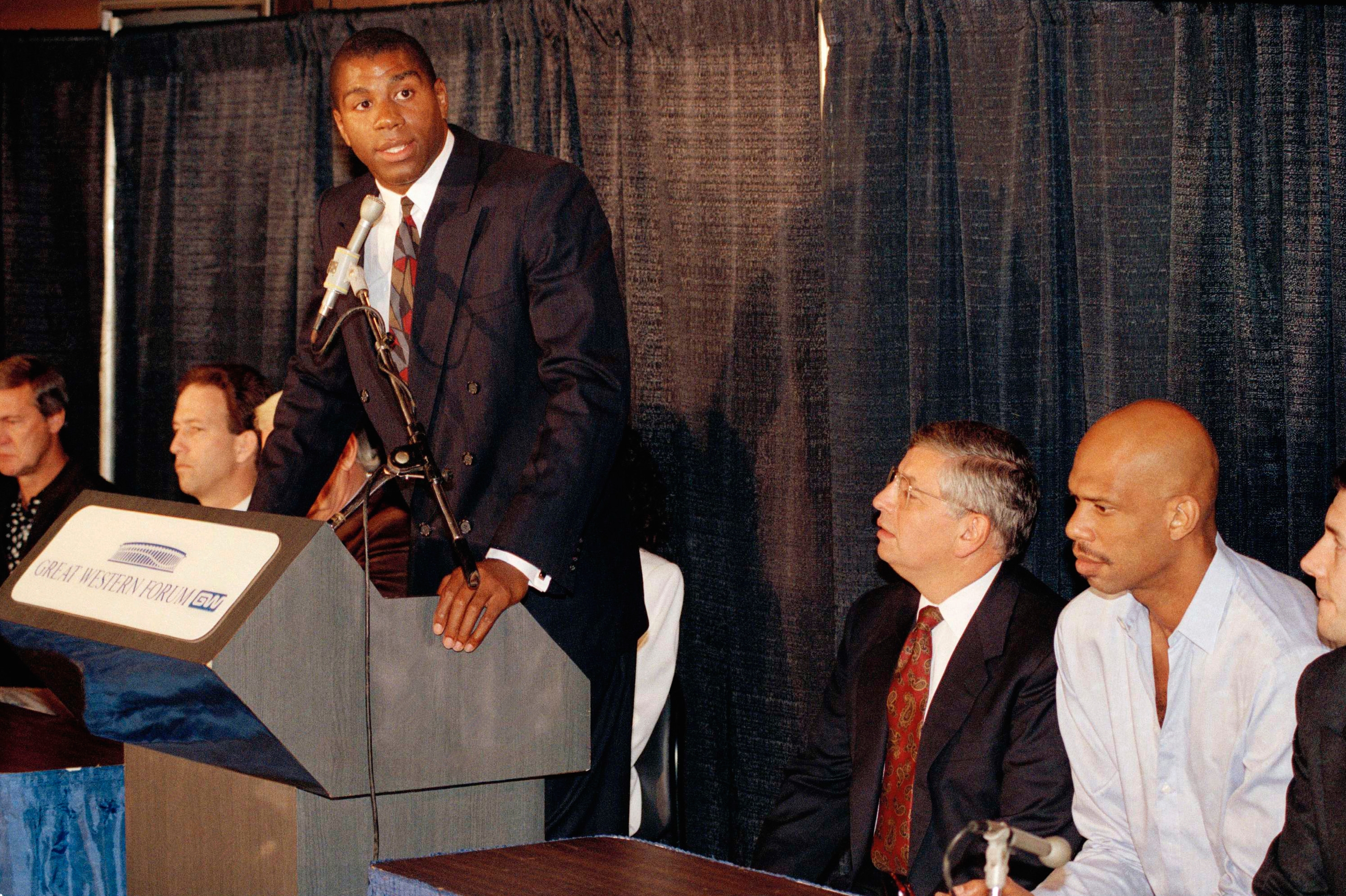 Then-NBA Commissioner David Stern stood by then-NBA star Earvin "Magic" Johnson when he announced he was HIV positive in 1991. Stern died Wednesday. (Mark J. Terrill–AP)
