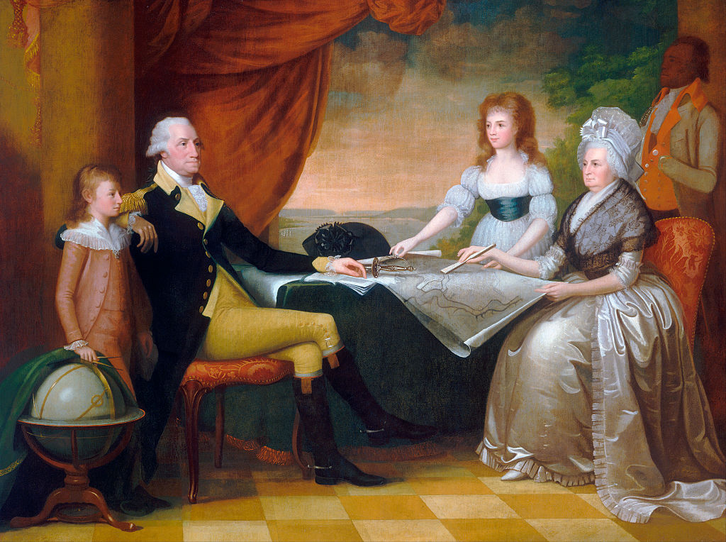 The Washington Family by Edward Savage (American, 1761 - 1817); oil on canvas, 1789 - 96, from the National Gallery, Washington, DC. The Washington family sits in a room overlooking the Potomac River in Washington, studying an architectural plan for the future grand construction of the capitol city. (GraphicaArtis/Getty Images)