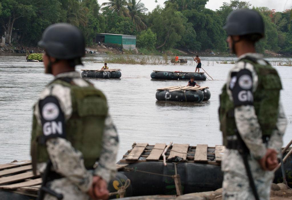 National Guard members stand guard along the banks of the Suchiate river in Ciudad Hidalgo, Chiapas State, Mexico, to prevent illegal crossings across the border river to and from Tecun Uman in Guatemala, on July 3, 2019. (STR/AFP via Getty Images)