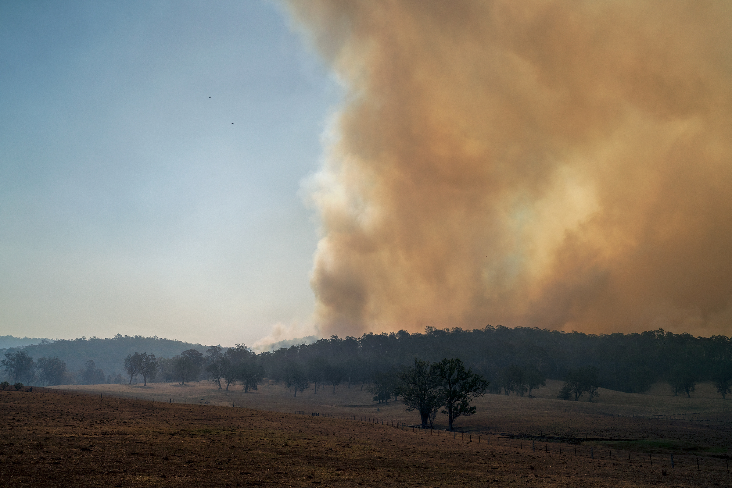Orange smoke fills the sky near a property north of Moruya, New South Wales, on Jan. 4. (Adam Ferguson for TIME)