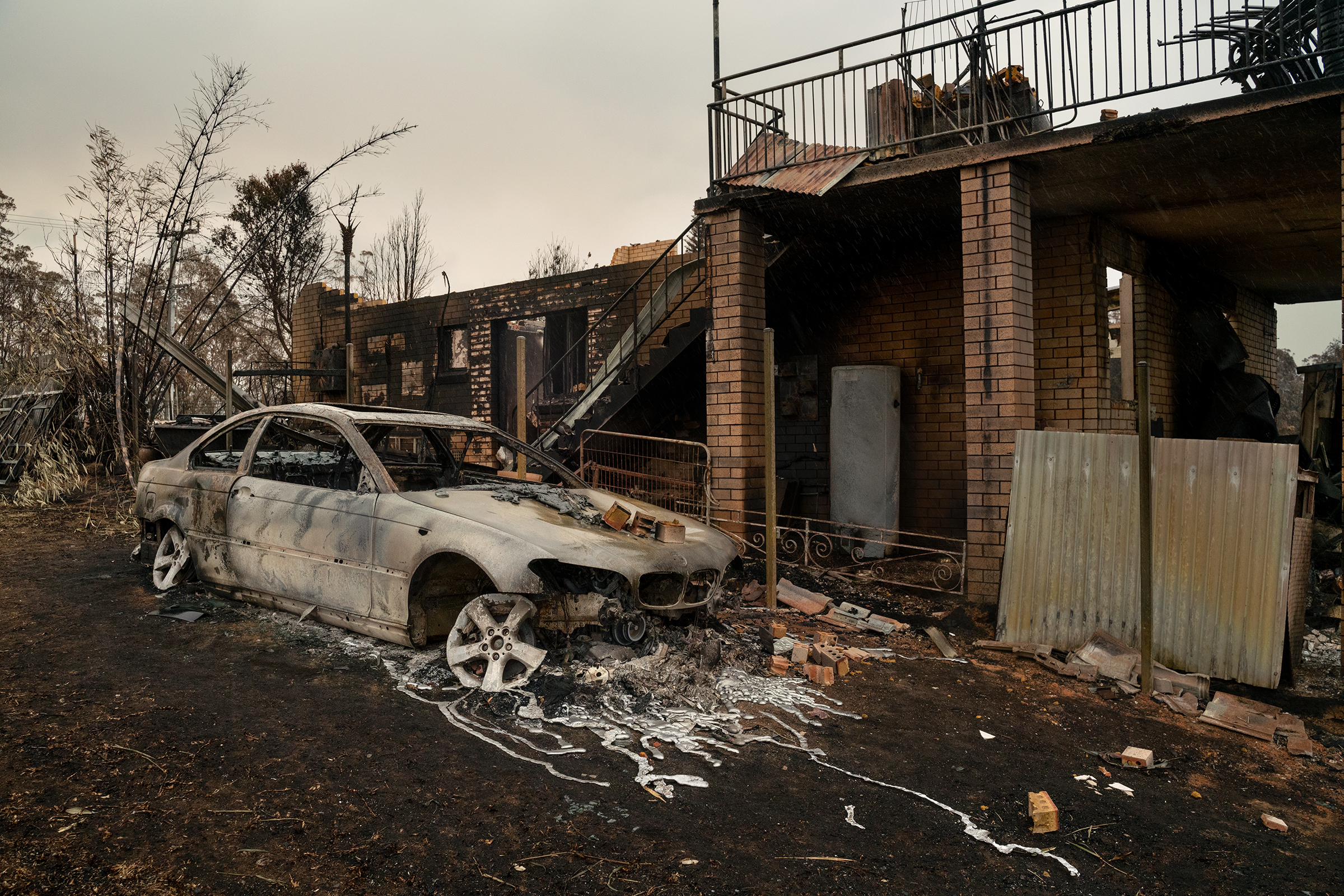 A damaged property and vehicle in Lake Conjola, New South Wales, on Jan. 5. (Adam Ferguson for TIME)