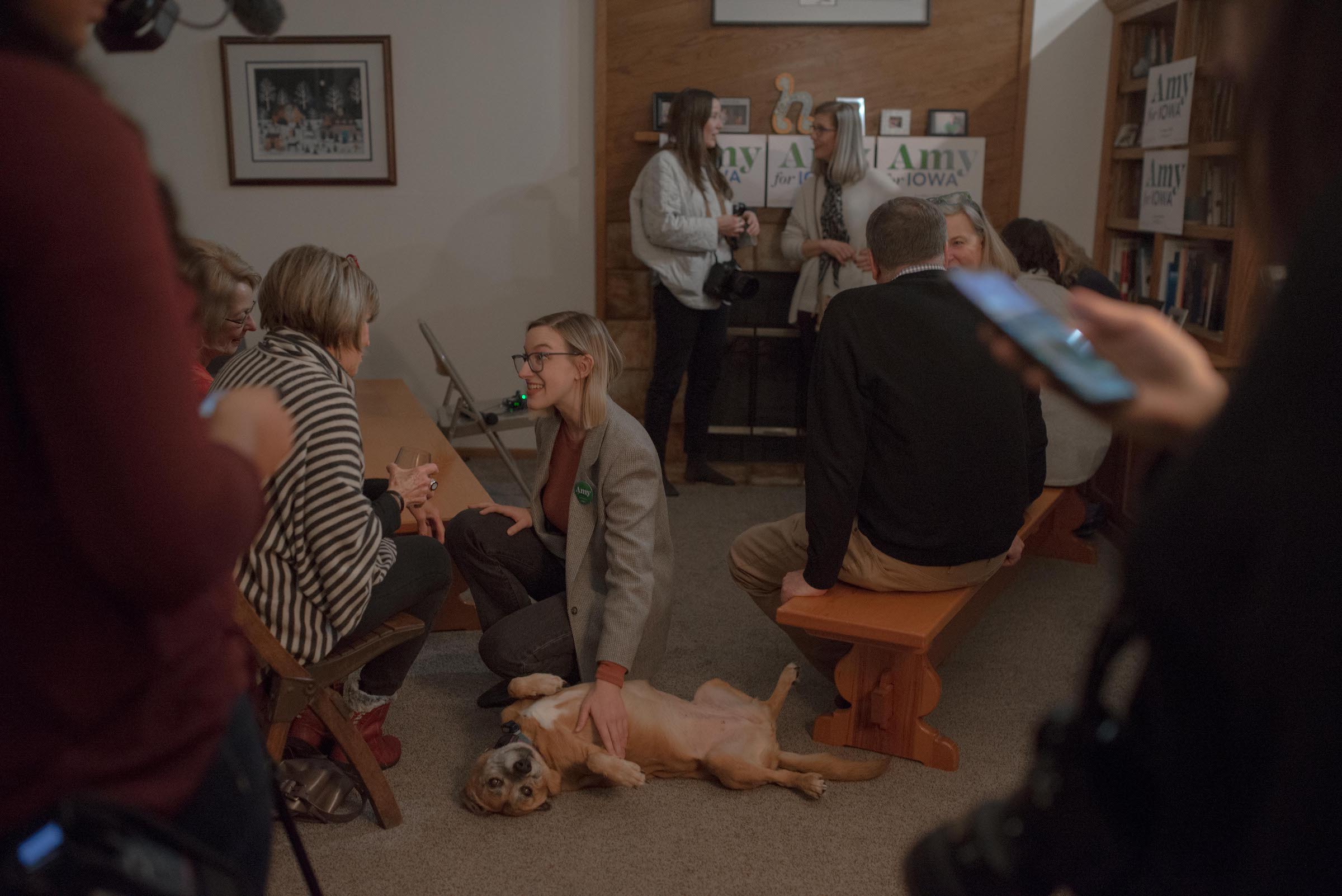 Abigail Bessler pets a dog while speaking with supporters at a Hotdish House Party. (September Dawn Bottoms for TIME)