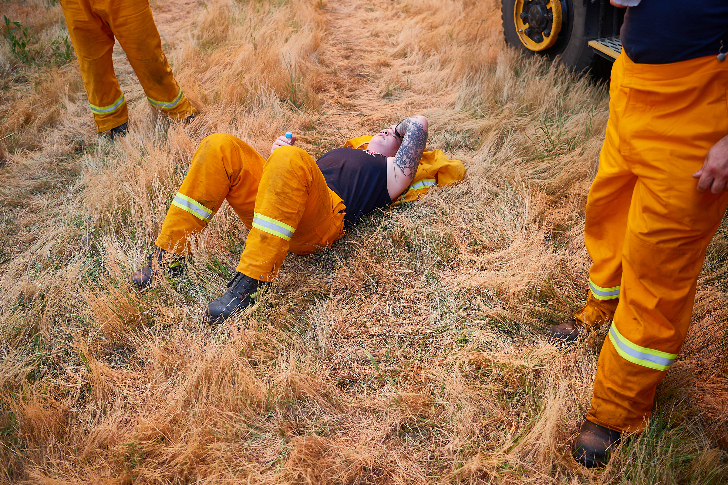 A Country Fire Authority crew member rests after a day of maintaining controlled back burns in St Albans on Nov. 21, 2019. (Brett Hemmings—Getty Images)