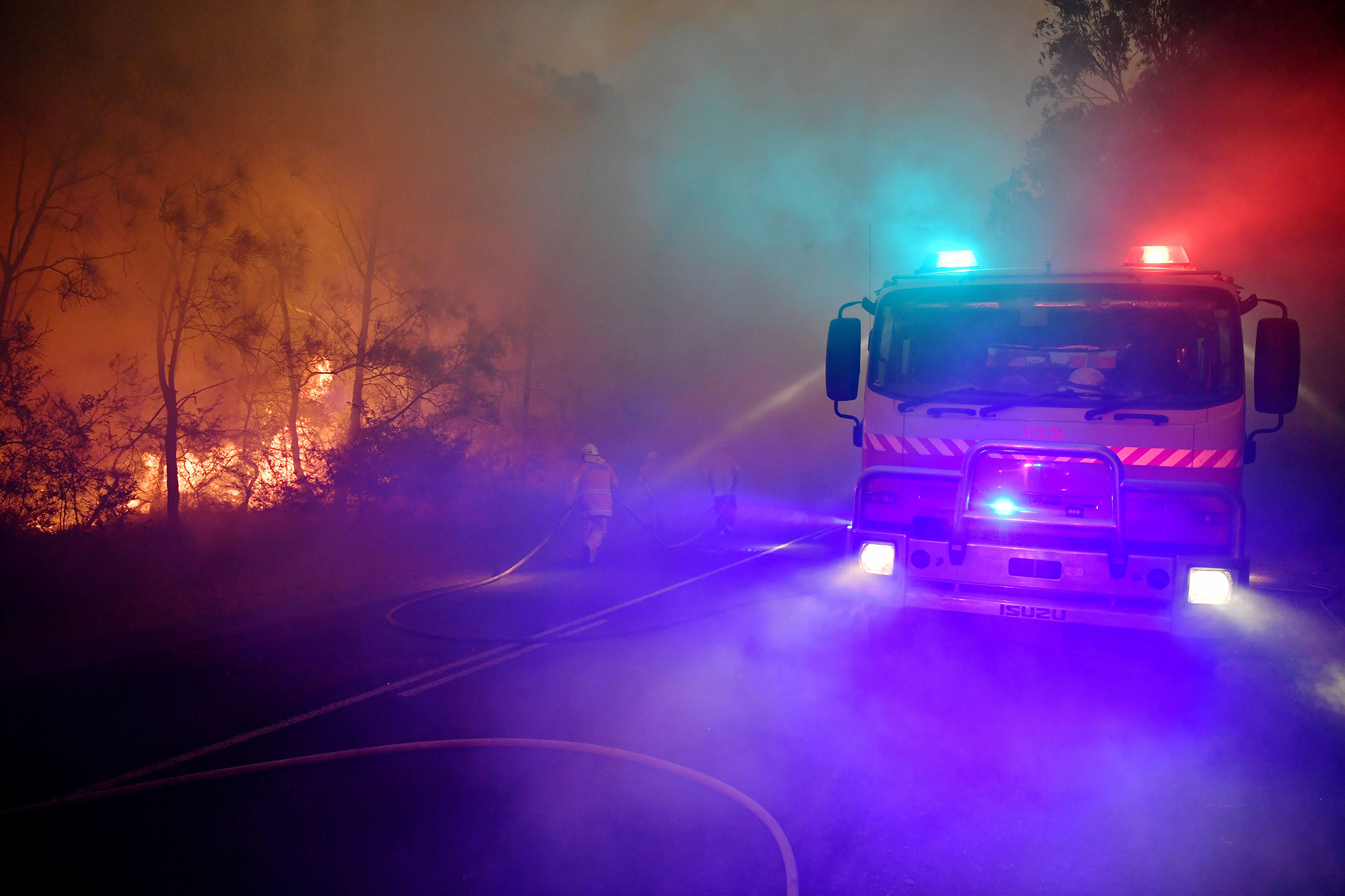Fire and rescue officers try to contain a bushfire near Kioloa, New South Wales, on Dec. 3, 2019. (Dean Lewins—EPA-EFE/Shutterstock)