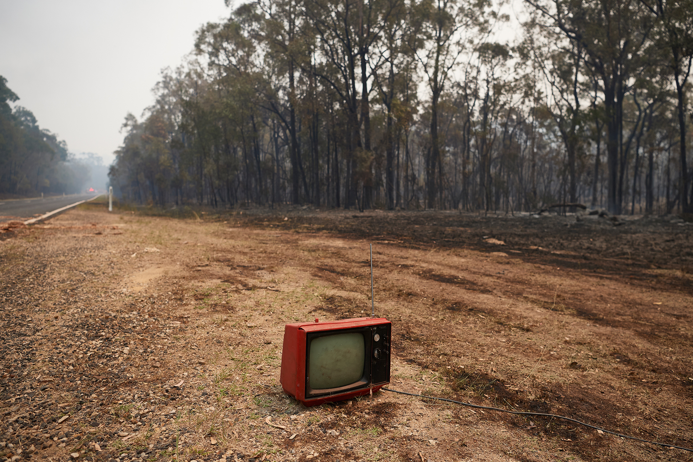 A dumped vintage TV remains intact along Putty Road after devastating fires tore through areas near Colo Heights on Nov. 14, 2019. (Brett Hemmings—Getty Images)