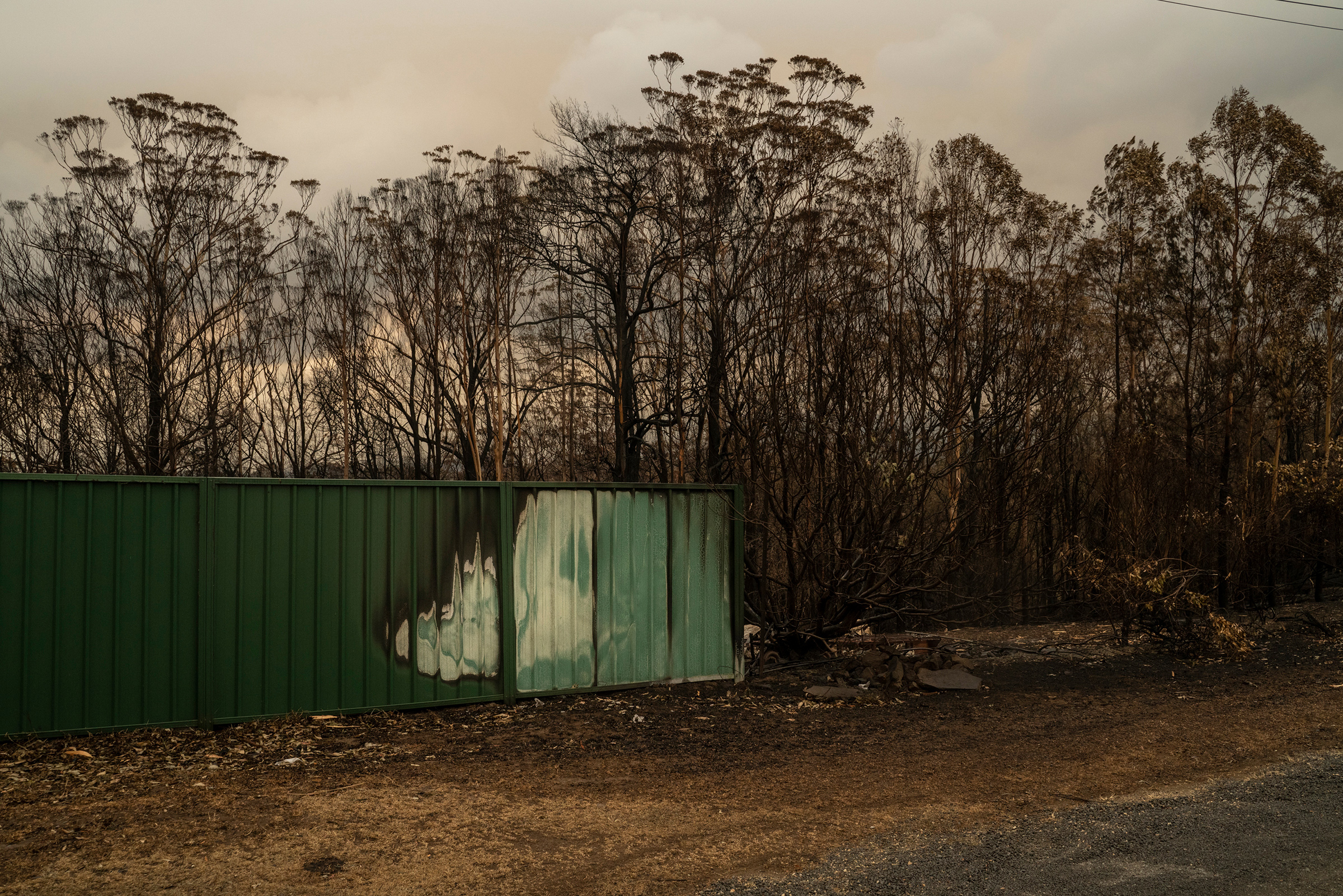A burned fence in Lake Conjola on Jan. 5. The community was devastated by flames in late December. (Adam Ferguson for TIME)