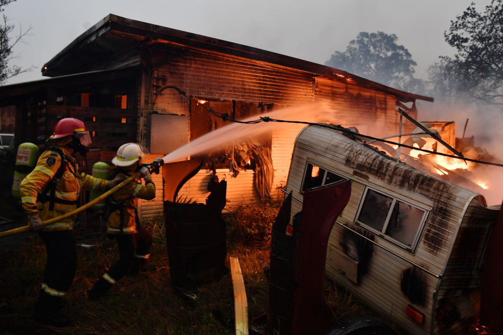 Rural Fire Service firefighters extinguish a fire on a property in Moruya, Australia on Jan. 23, 2020. (Sam Mooy&mdash;Getty Images)