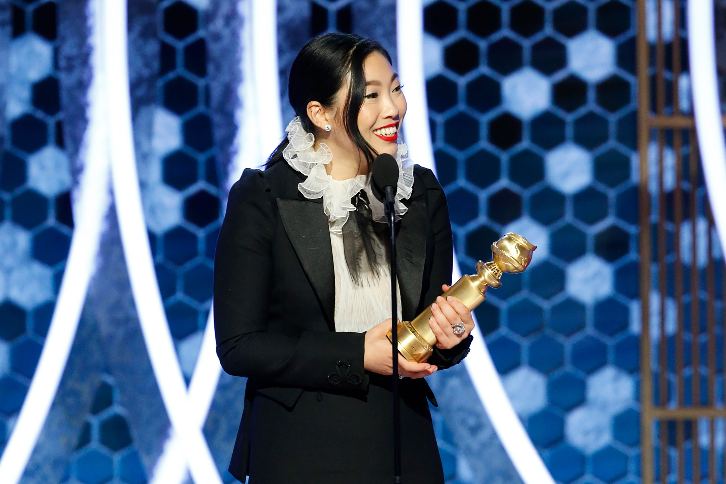 Awkwafina accepts the award for best performance by an actress in a motion picture - musical or comedy for "The Farewell" onstage during the 77th Annual Golden Globe Awards. (Paul Drinkwater—NBCUniversal/Getty Images.)
