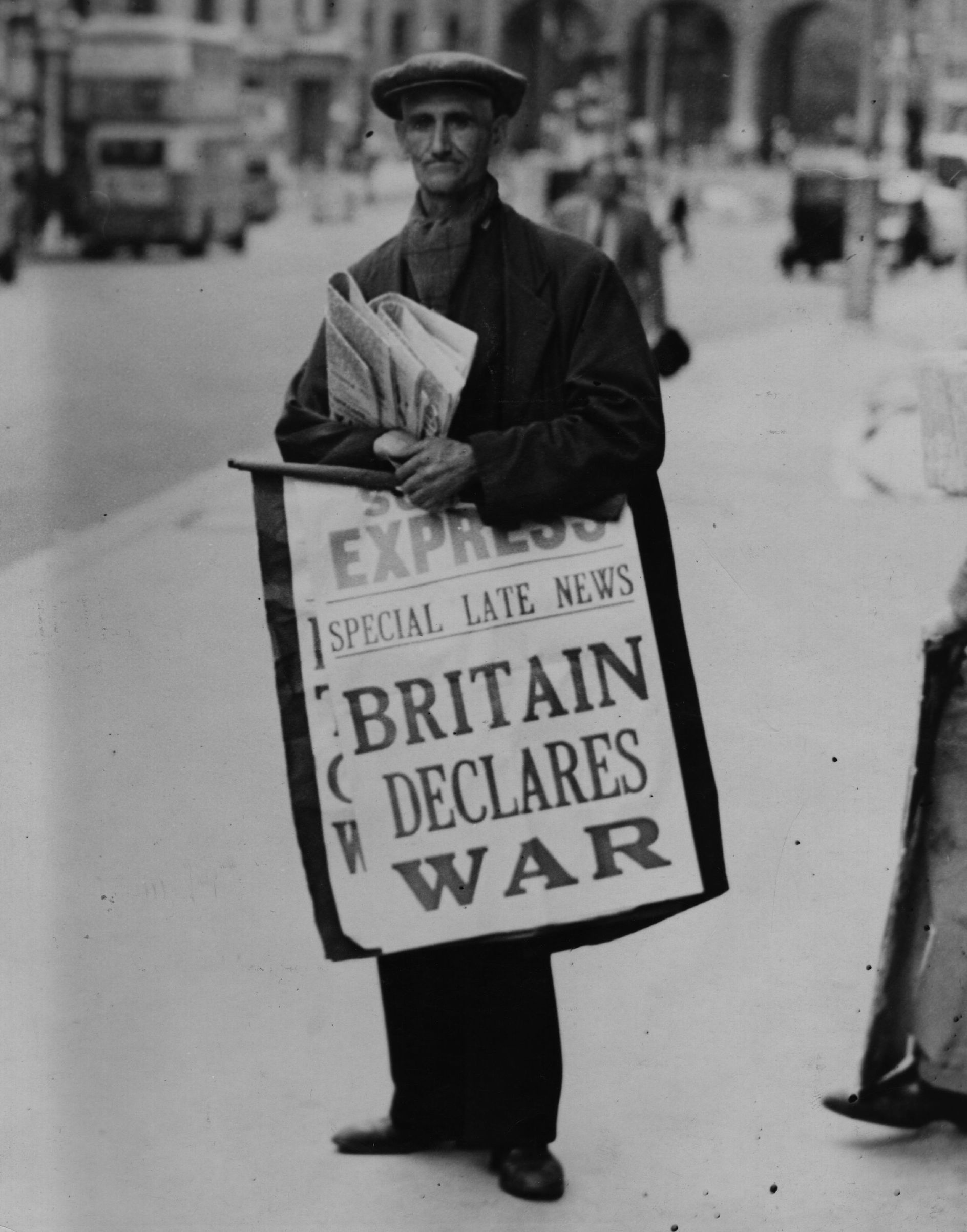 A newspaper seller carries a hoarding pronouncing the declaration of war between Britain and Germany, on the Strand, heading towards Admiralty Arch in London on Aug. 1, 1939. (Getty Images)