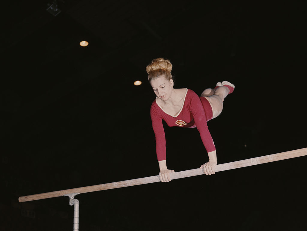 Czechoslovakian gymnast and seven-time Olympic Gold medallist Vera Caslavska competes on the uneven bars in 1968 in London, Great Britain. (Don Morley/Getty Images)