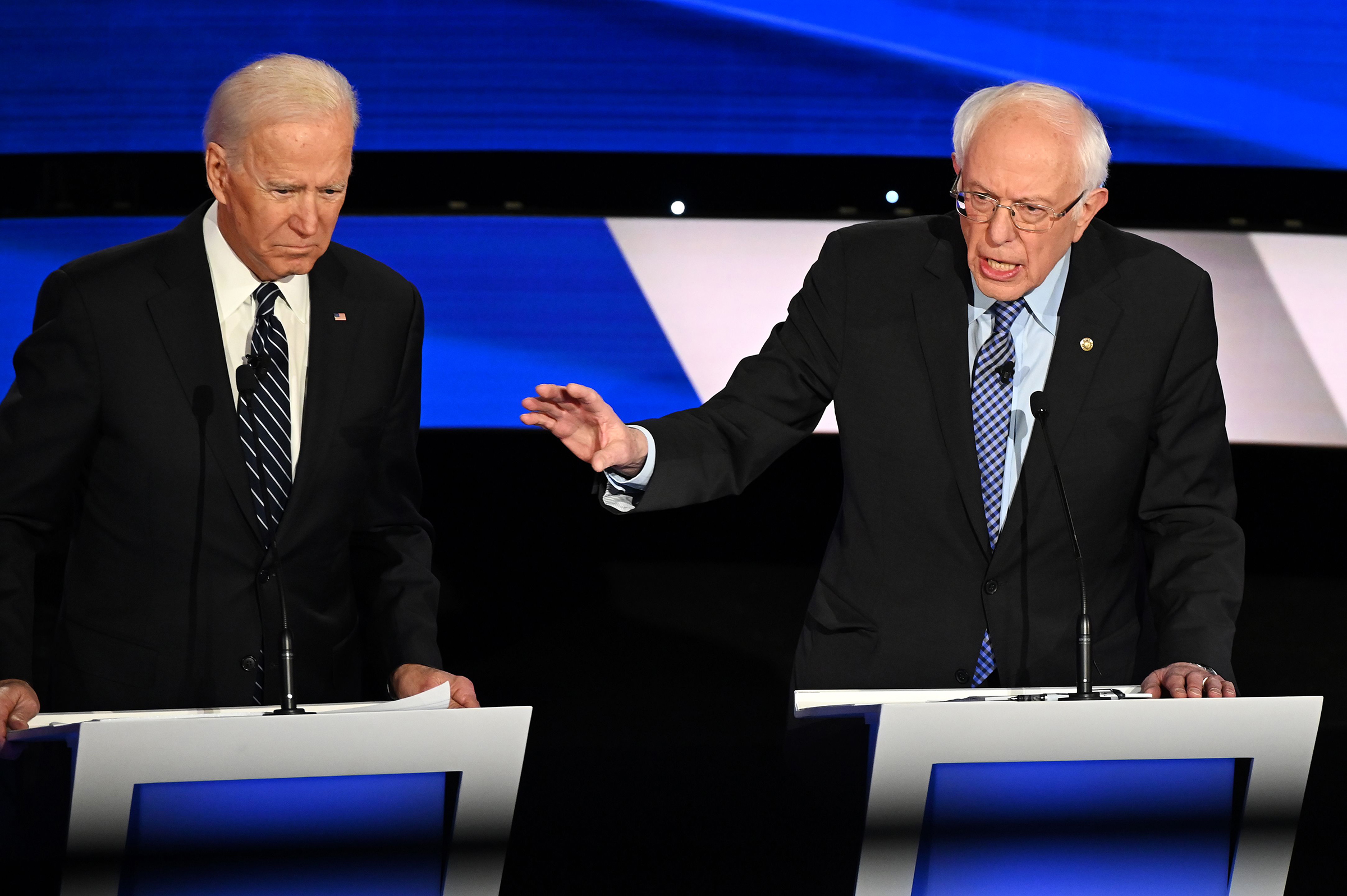 (L-R) Democratic presidential hopefuls Former Vice President Joe Biden (L) and Vermont Senator Bernie Sanders participate in the seventh Democratic primary debate of the 2020 presidential campaign in Des Moines, Iowa on Jan. 14, 2020. (Robyn Beck—AFP via Getty Images)