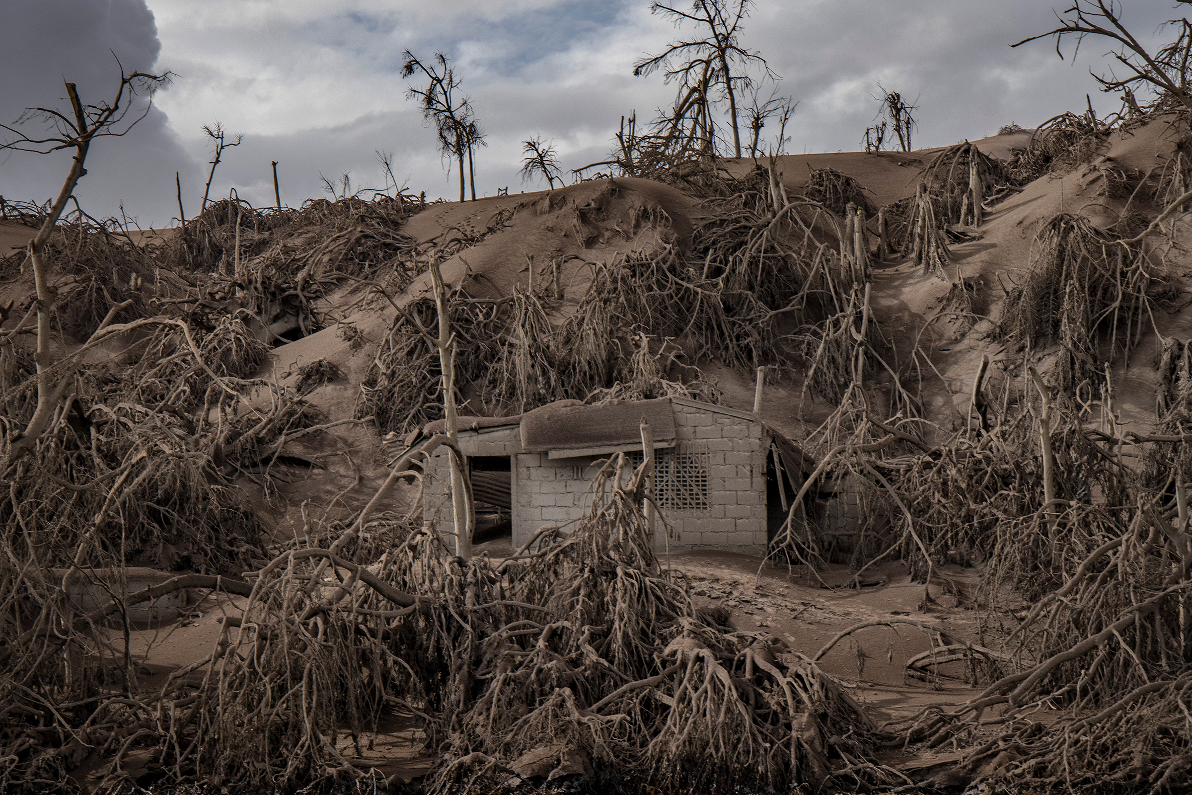 A house near the crater is buried in ash. (Ezra Acayan—Getty Images)