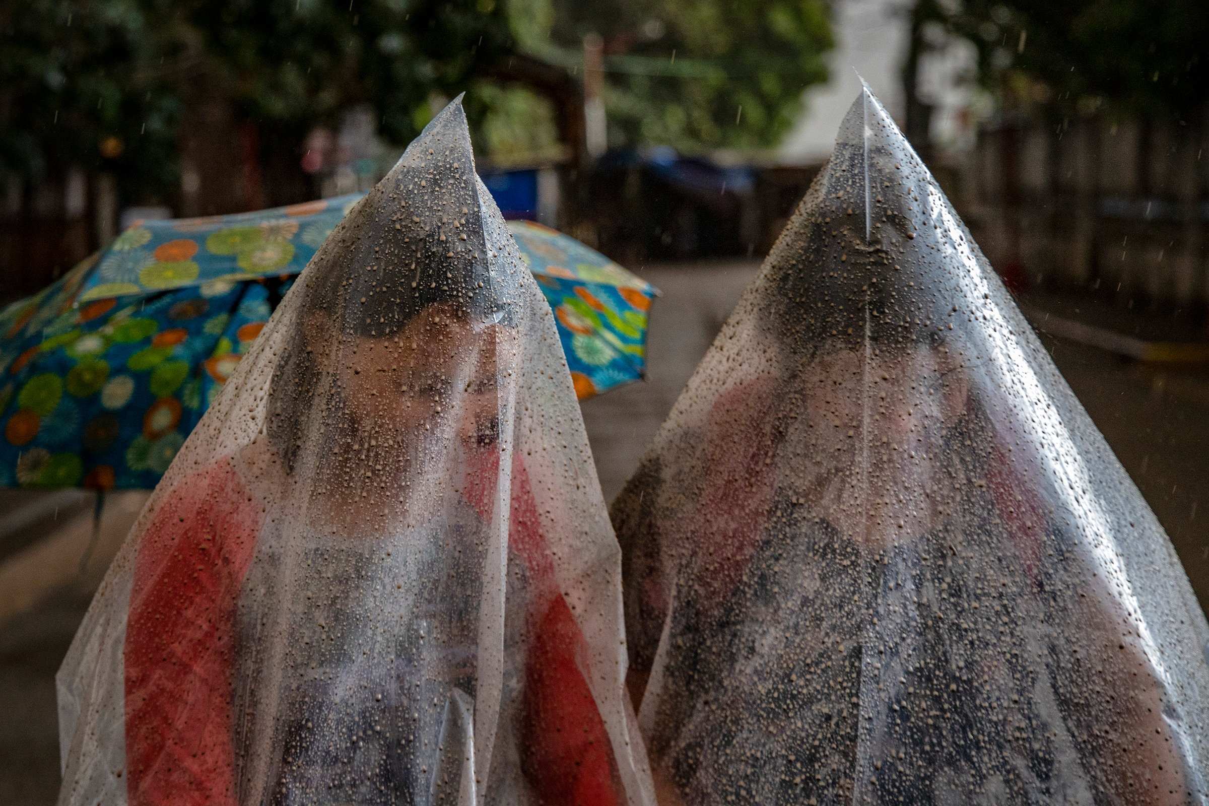 Residents in Talisay use plastic bags to shield themselves from ash and rainwater on Jan. 12. (Ezra Acayan—Getty Images)