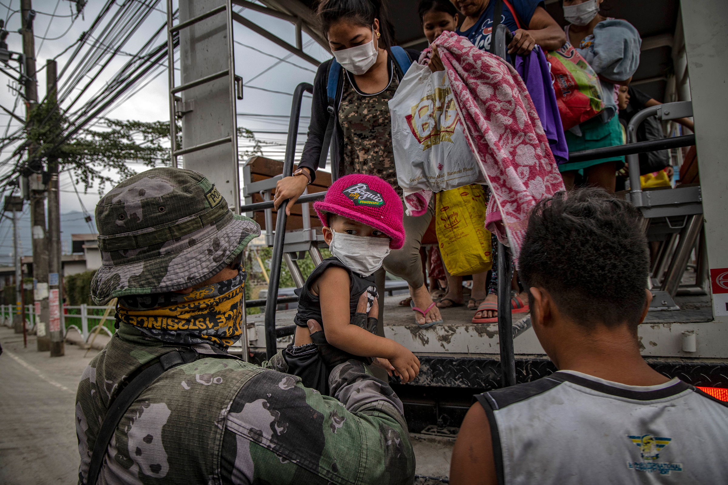 Residents fleeing the eruption arrive to an evacuation center in Santo Thomas on Jan. 13. (Ezra Acayan—Getty Images)