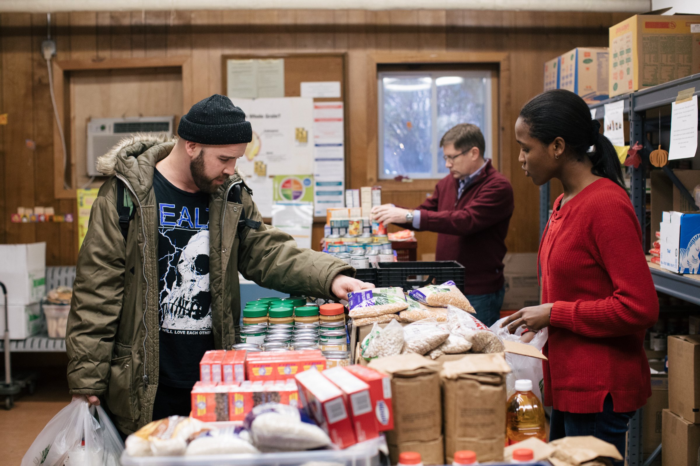 A volunteer helps a patron, on the left, at the St. Ignatius Church food pantry on Chicago’s North Side, part of the Greater Chicago Food Depository’s network.