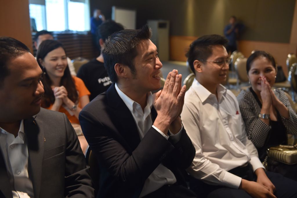 Thanathorn Juangroongruangkit (C), leader of the Future Forward party, with party officials and supporters at their headquarters to watch a broadcast of a ruling by Thailand's Constitutional Court in Bangkok on Jan. 21, 2020. (Romeo Gacad&mdash;AFP/Getty Images)