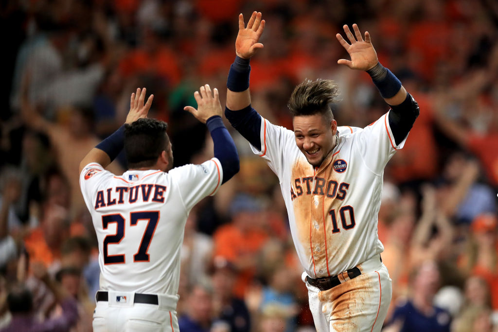 Yuli Gurriel #10 of the Houston Astros celebrates with teammate Jose Altuve #27 after scoring off of a double hit by Brian McCann #16 against Tommy Kahnle #48 of the New York Yankees during the fifth inning in Game Seven of the American League Championship Series at Minute Maid Park on October 21, 2017 in Houston, Texas. (Getty Images&mdash;2017 Getty Images)