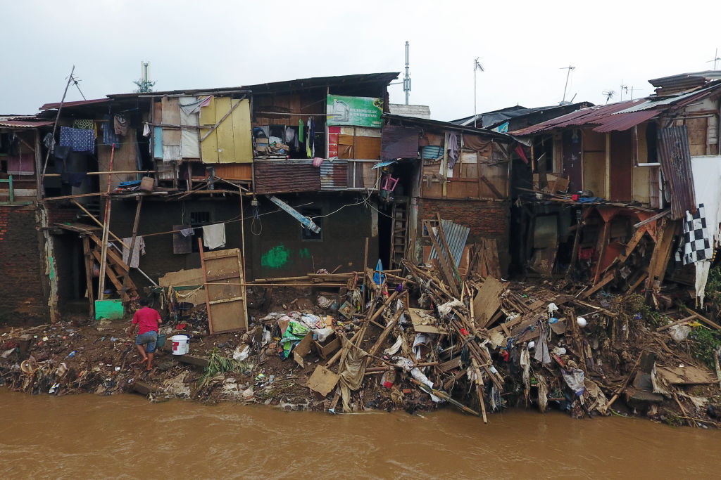 Structures damaged by floods stand along the Ciliwung River in the Mangarai district of Jakarta, Indonesia, on Jan. 4, 2020. (Dimas Ardian—Bloomberg/Getty Images)