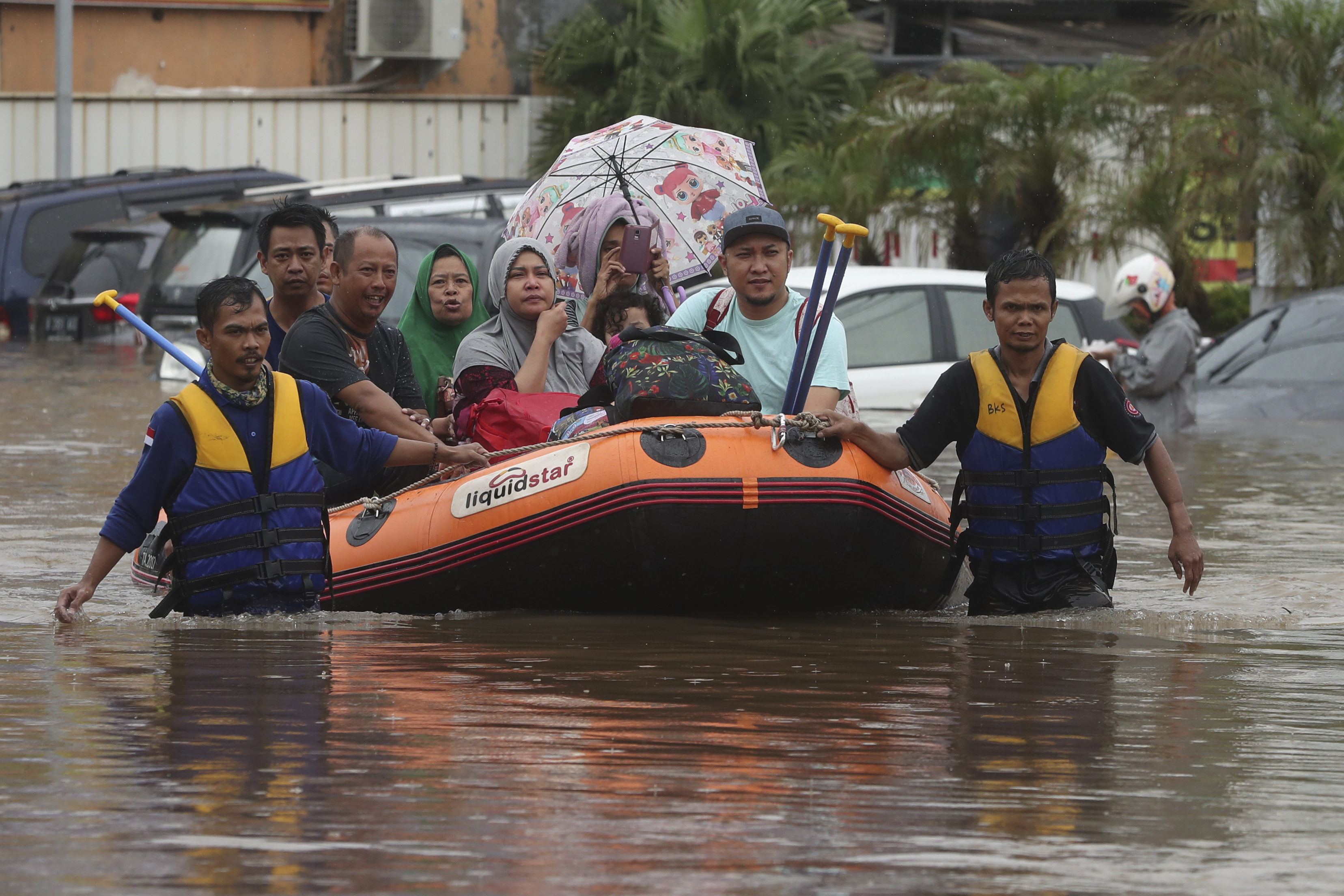 A rescue team evacuates residents from their flooded house at Jatibening on the outskirts of Jakarta, Indonesia, on Jan. 1, 2020. (Achmad Ibrahim—AP)