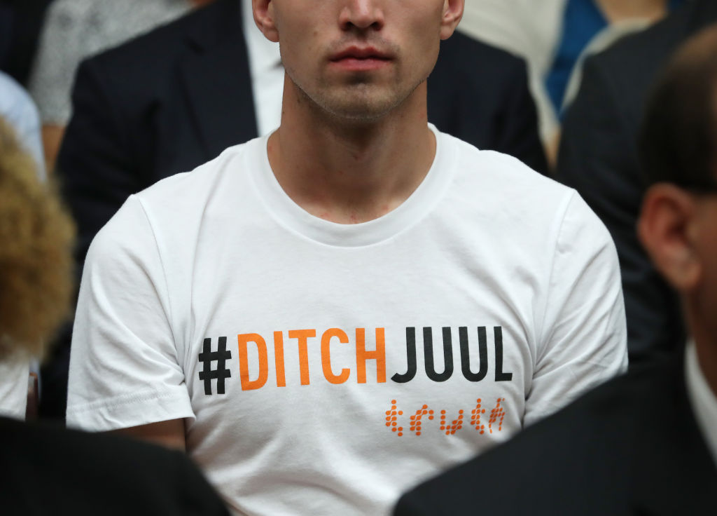 A young man wears a shirt that reads DITCHJUUL while James Monsees, co-founder of JUUL Labs, testifies before Congress in Washington, DC on July 25, 2019. ((Photo by Mark Wilson/Getty Images))