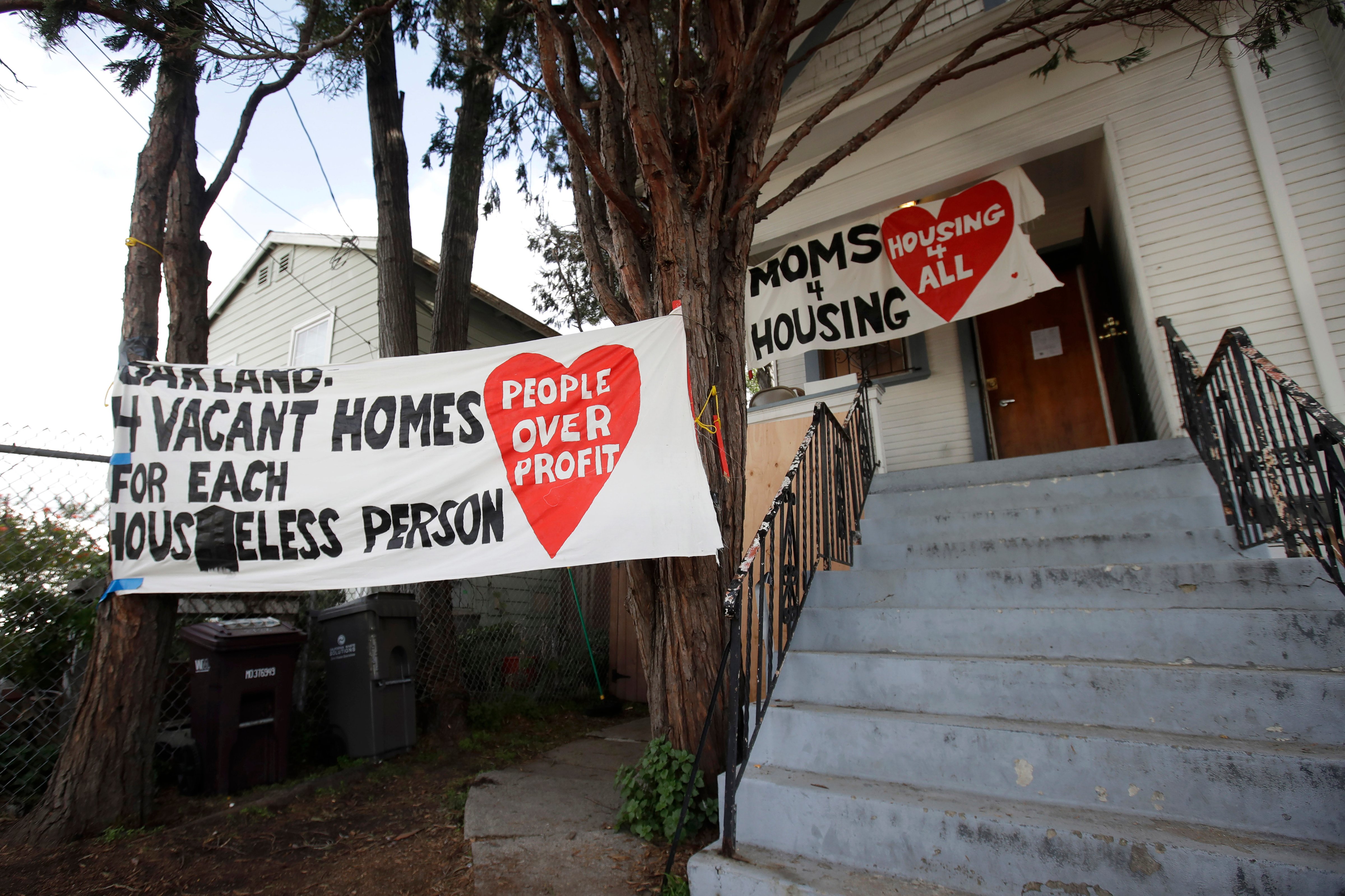 Signs are posted outside of a house that was occupied by homeless women in Oakland, Calif., on Jan. 14, 2020. (Jeff Chiu—AP)