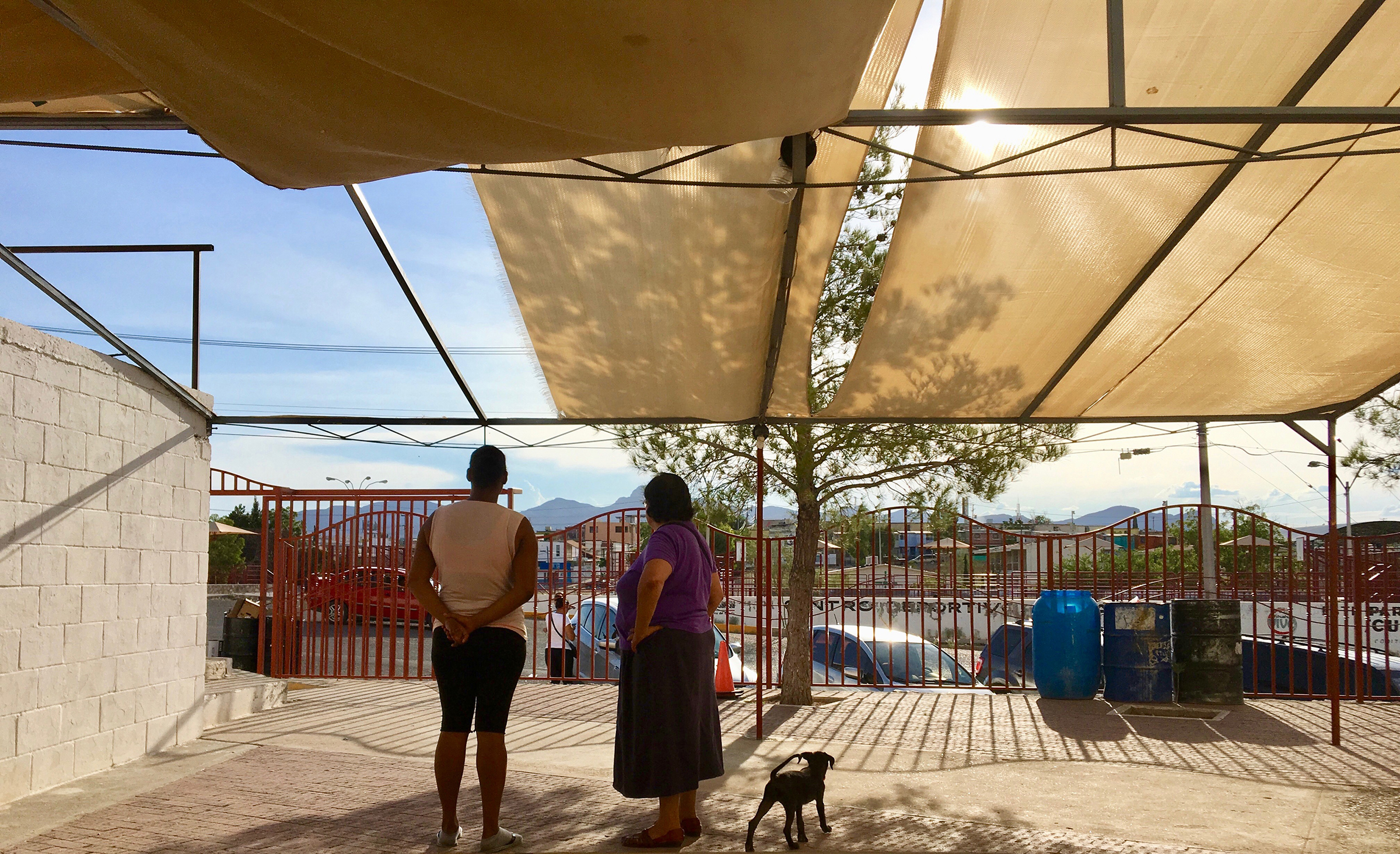 Sister Maria Antonia Aranda and a migrant woman from Cuba conferring outside a church in Juárez, Mexico in August 2019. (Courtesy of  Lily Moore-Eissenberg)