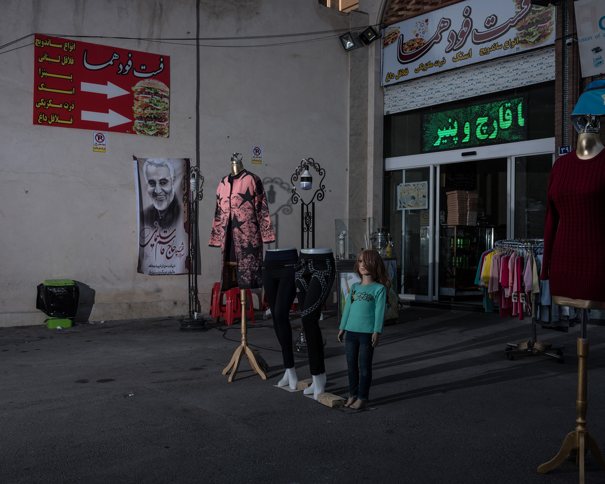 A poster of Soleimani hangs at a bazaar in the south of Tehran. (Newsha Tavakolian—Magnum Photos for TIME)