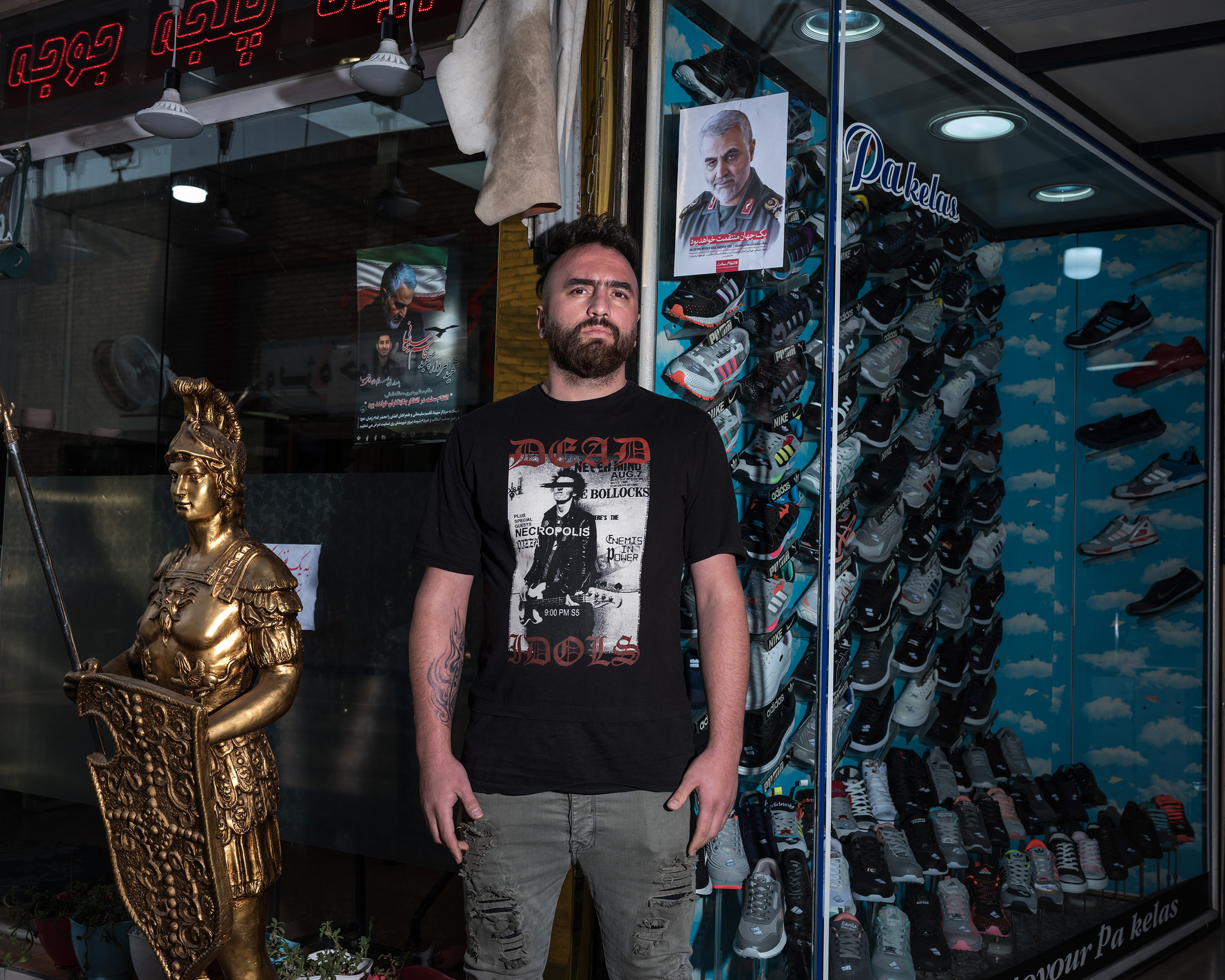 Ali, 29, sells shoes near the shrine to Shah Abdol Azim in Tehran. He hung a poster of Soleimani "out of respect for what he did for Iran." (Newsha Tavakolian—Magnum Photos for TIME)