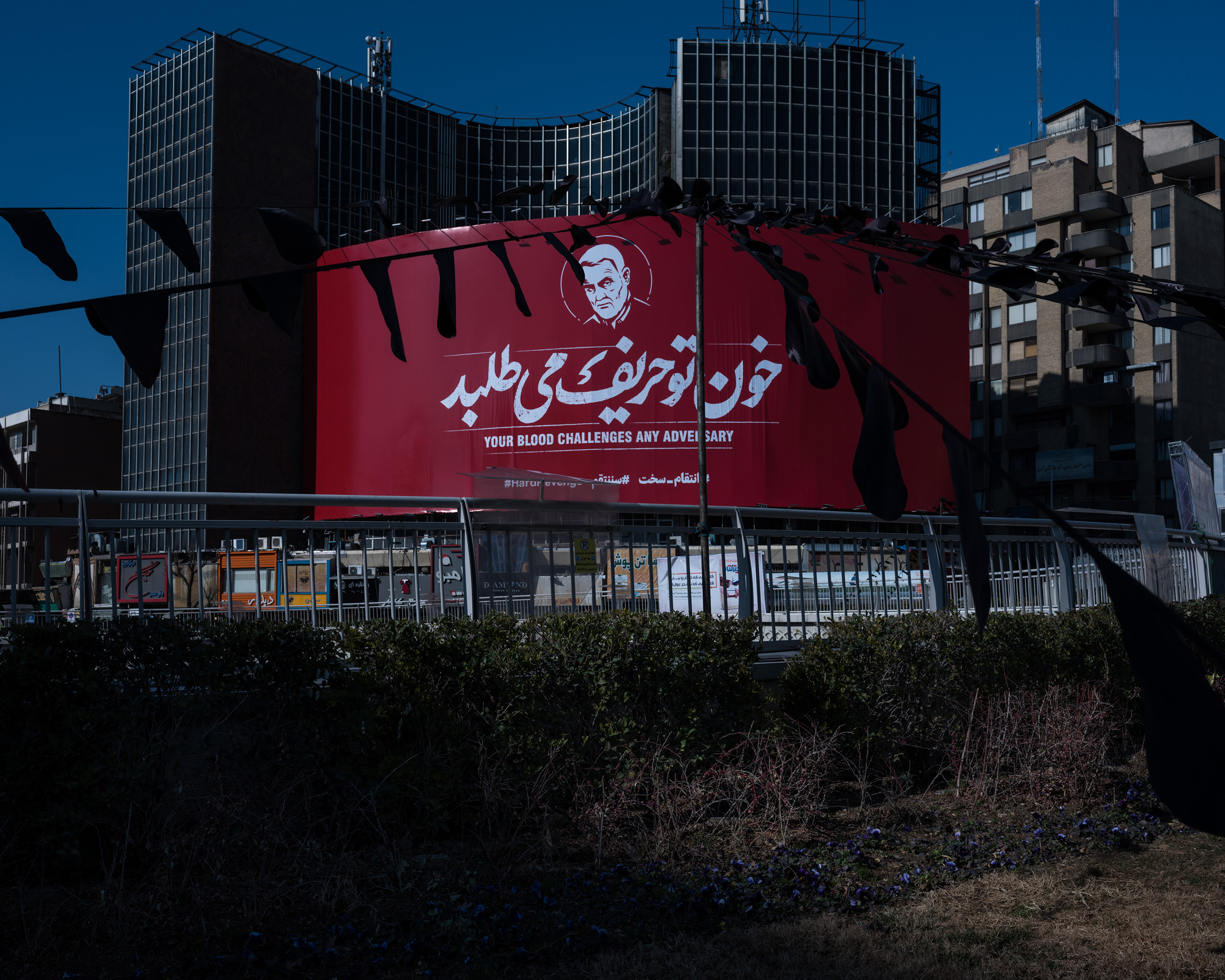 A massive banner showing Soleimani's likeness with the hashtag #HardRevenge hangs at Tehran’s central Vali-e Asr Square. (Newsha Tavakolian—Magnum Photos for TIME)