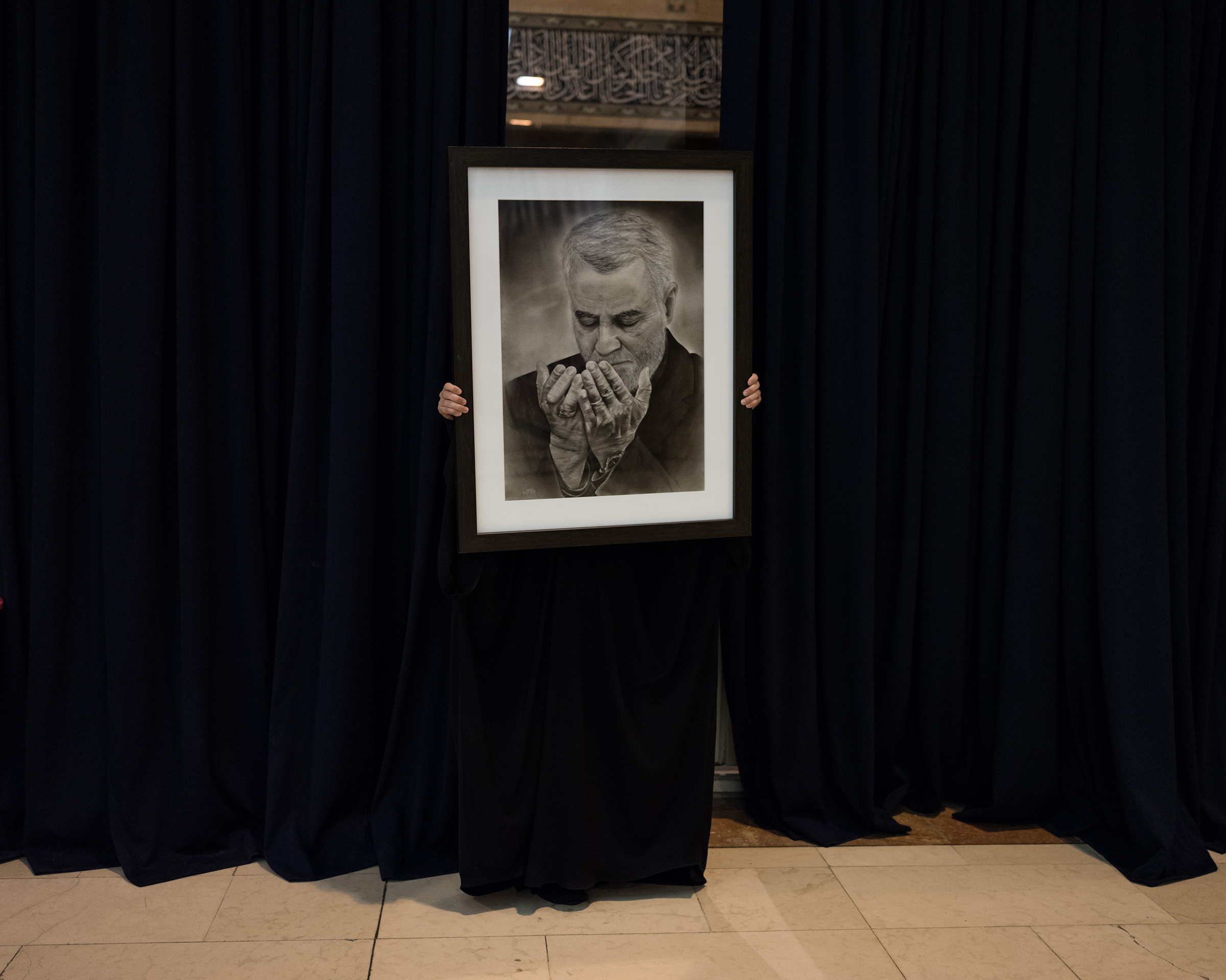 A portrait of Soleimani is held during the three official days of mourning. (Newsha Tavakolian—Magnum Photos for TIME)